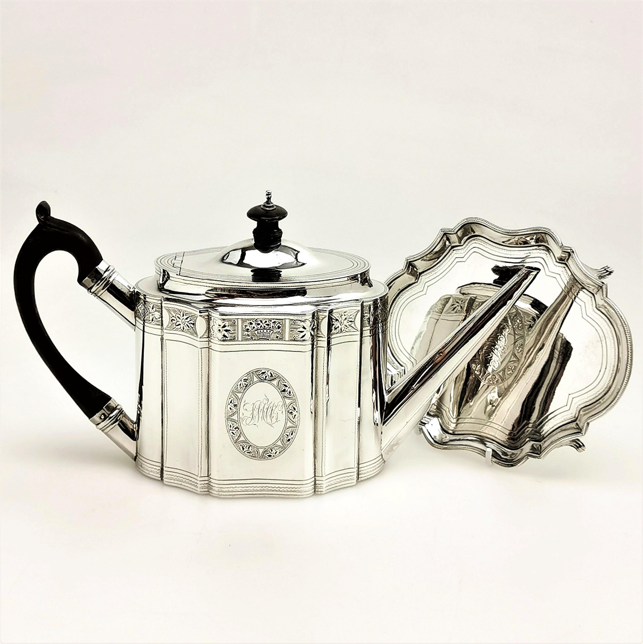 A lovely Antique Georgian Silver Teapot on Stand. The shaped Teapot stands on a matching shaped tray, each embellished with delicate bright cut engraving. Both Teapot and Stand have an engraved monogram in an oval cartouche, while the Teapot has a