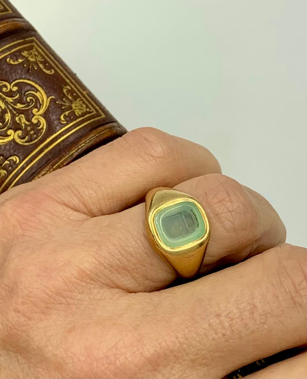Antique 19th century Georgian style 18K yellow gold ochre glass intaglio Baronet signet ring
Substantial, fine quality 18K yellow gold Baronet signet ring with a very unusual intaglio shield shaped crest with three palm fronds. 
Palms are symbolic