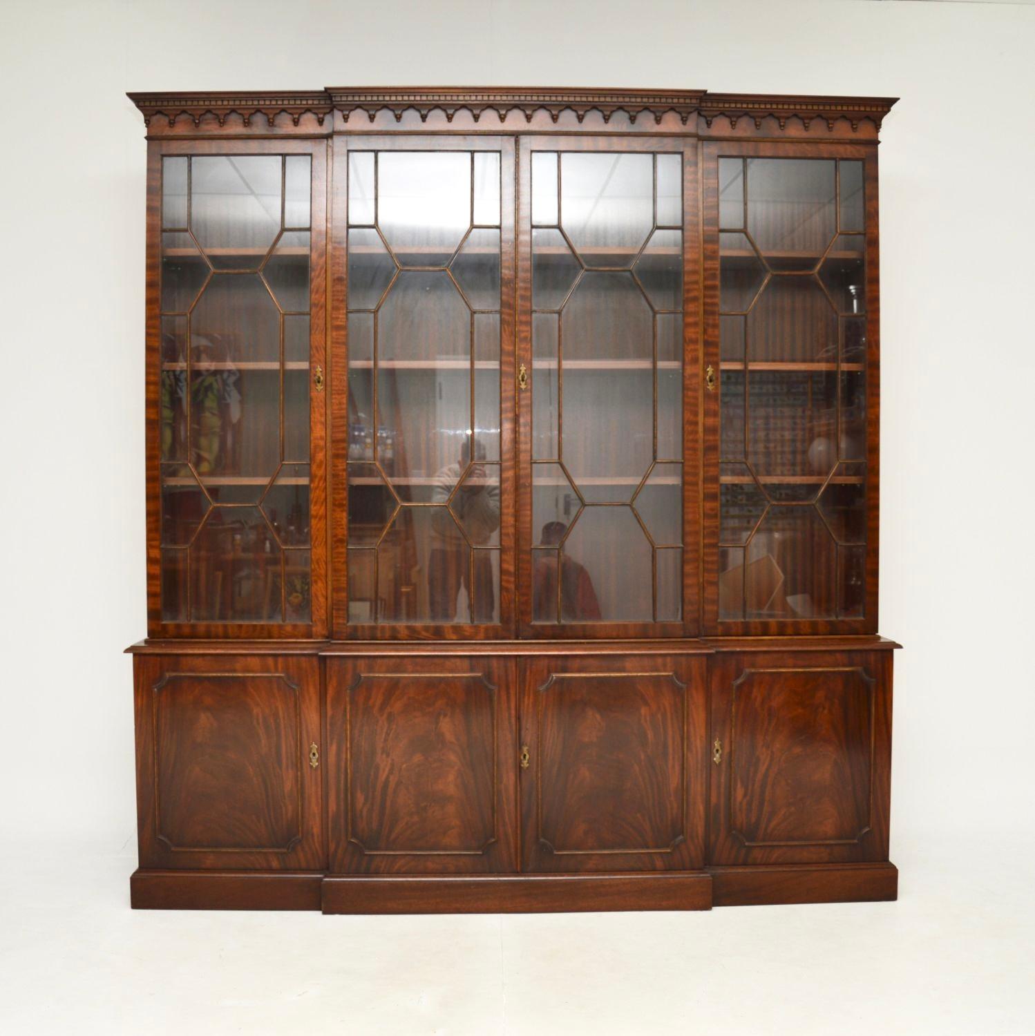 A large and impressive antique Georgian style breakfront bookcase. This was made in England, it dates from around the 1930-1950’s.

It is of superb quality, with fantastic proportions and lots of storage space. It sits on a plinth base with four