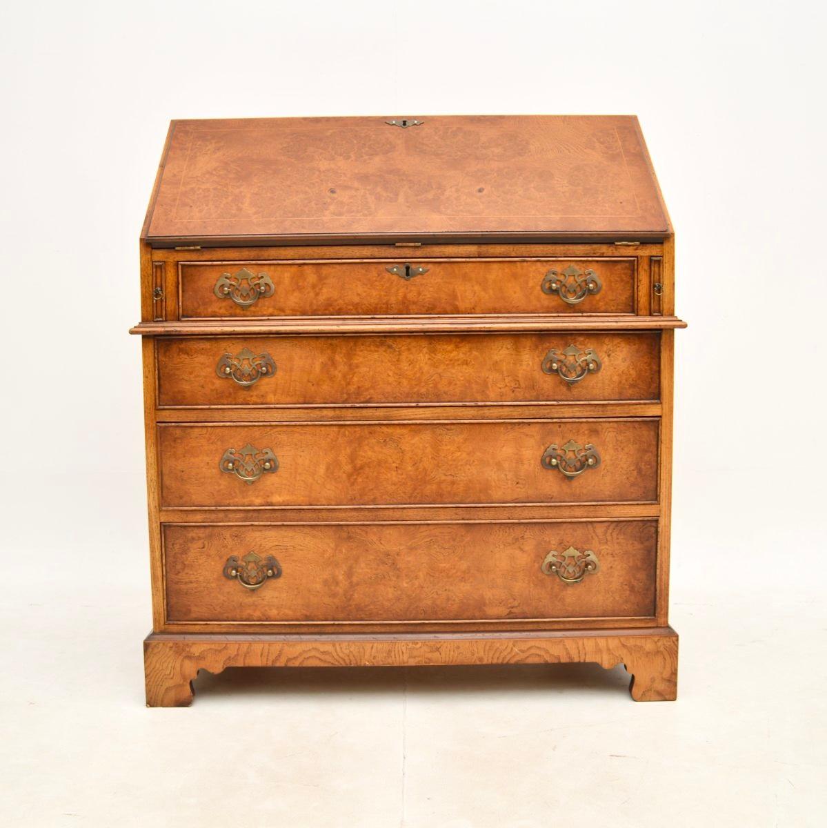 A superb antique Georgian style burr elm writing bureau. This was made in England, it dates from around the 1930’s.

The quality is outstanding, this is a great size with lots of work space and storage space in the drawers below. The burr elm grain