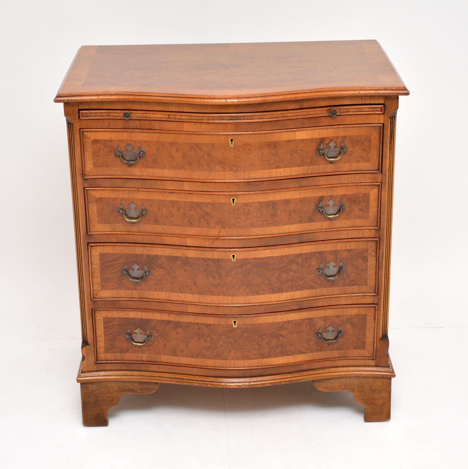Antique walnut George III style serpentine shaped chest of drawers in excellent condition & dating from the 1930s period.

The top & the drawer fronts are burr walnut with figured walnut cross bandings. There is a brushing slide above the four