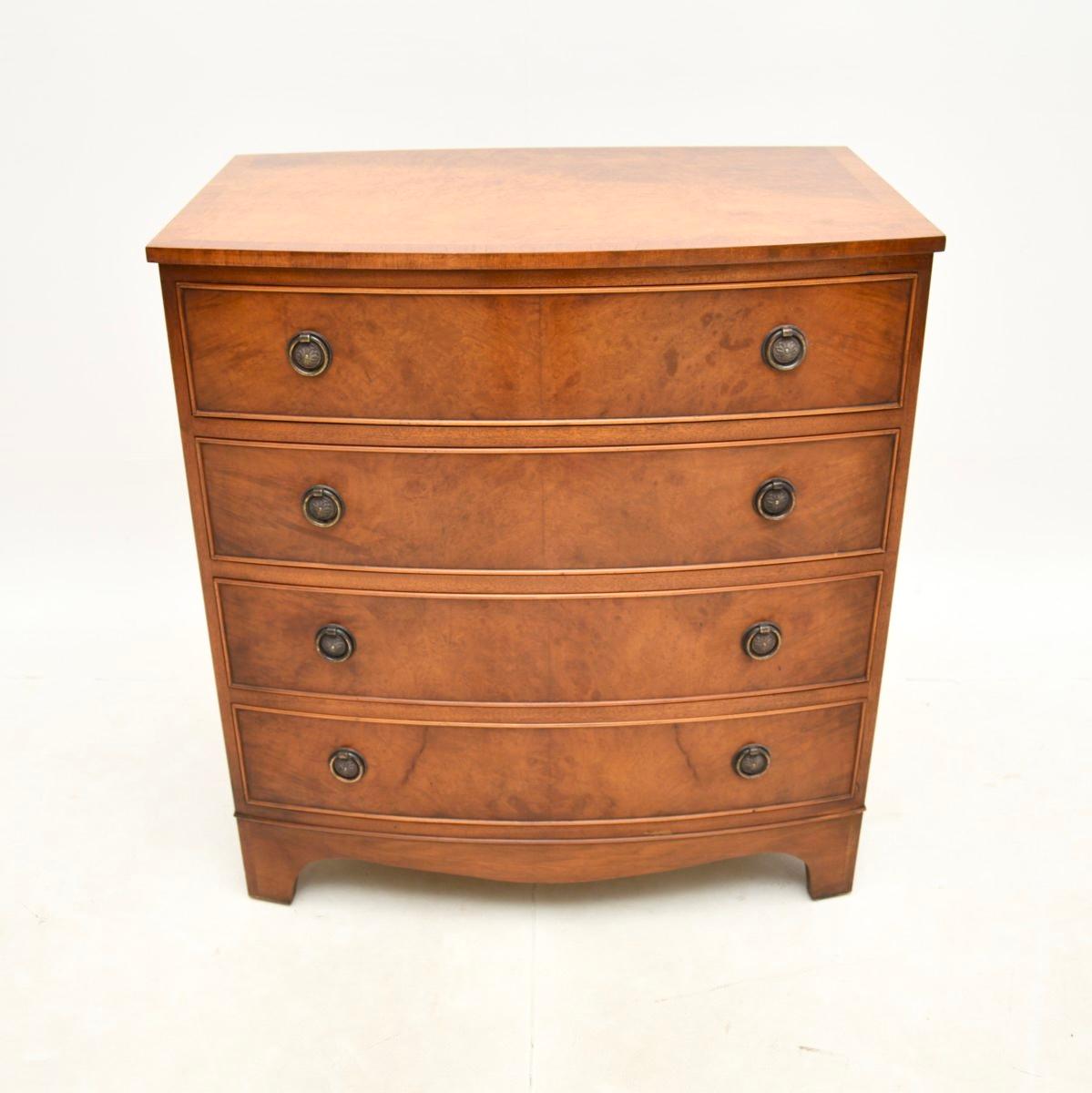 A charming antique Georgian style burr walnut chest of drawers. This was made in England, it dates from around the 1950’s.

The quality is fantastic, this is a useful size with lots of storage space. It has a bow fronted shape, sits on bracket feet