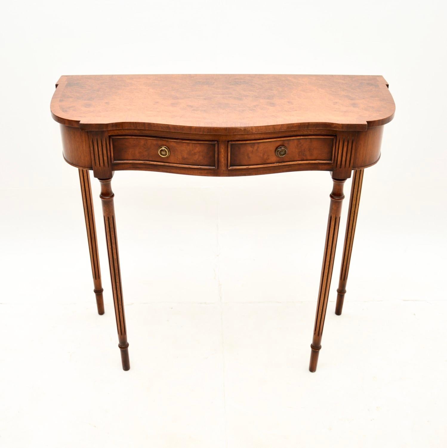 A fine and very well made antique Georgian style burr walnut console table. This was made in England, it dates from around the 1930-50’s.

It is of superb quality and is a very useful size. It is slim and elegant yet sturdy, the top has a serpentine