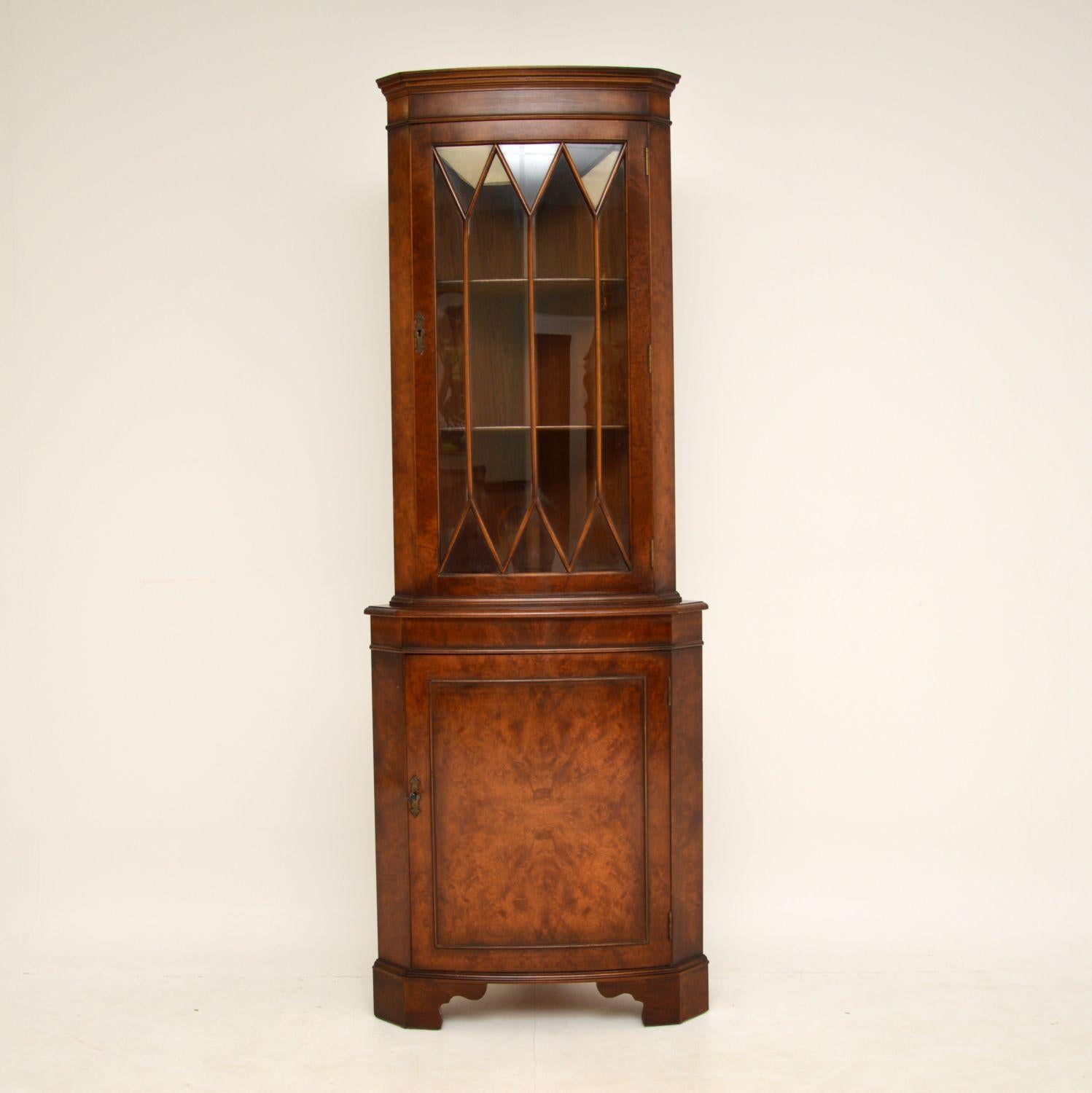 A smart and useful walnut corner cabinet in the antique Georgian style. this dates from around the 1950’s period.

It is of lovely quality, with a lovely colour and gorgeous burr walnut grain patterns. This sits on bracket feet, and has an astral