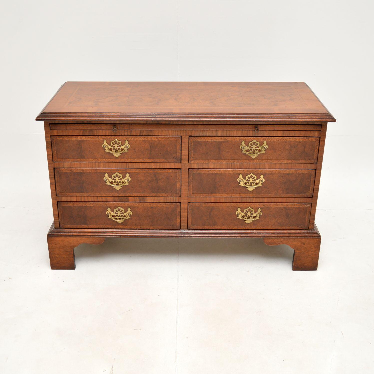 A smart and very well made antique Georgian style burr walnut low boy chest of drawers. This was made in England, it dates from around the 1920-30’s period.

It is a beautifully designed and very useful item, low and compact, with lots of storage