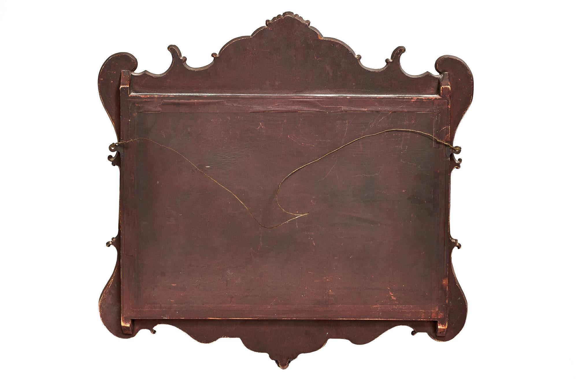 Antique Georgian style carved walnut wall mirror having a beautiful walnut frame with an expertly carved leaf detail and parcel gilt decoration. 


 