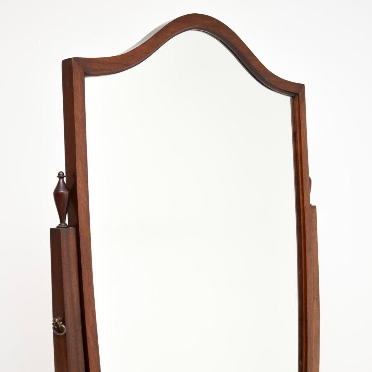 A large and very impressive antique Georgian style cheval mirror. This was made in England, it dates from around the 1950’s.

It is of outstanding quality with a fantastic design. The large mirror frame is shield shaped, the supports are beautifully