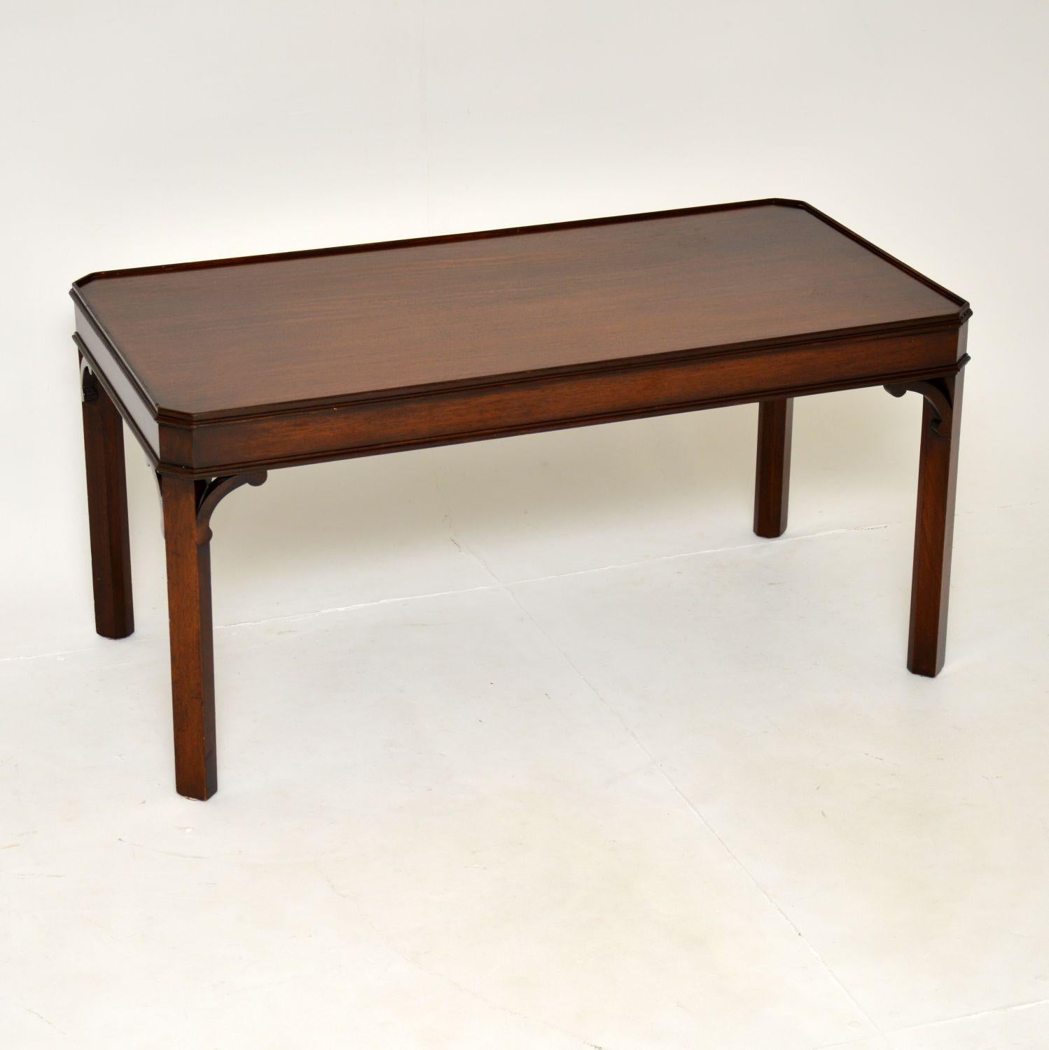 A smart and very well made antique wood coffee table in the Georgian style. This was made in England & I would date it from around the 1950’s period.

It is very well made and is a useful size. The design is simple yet stylish, with cantered