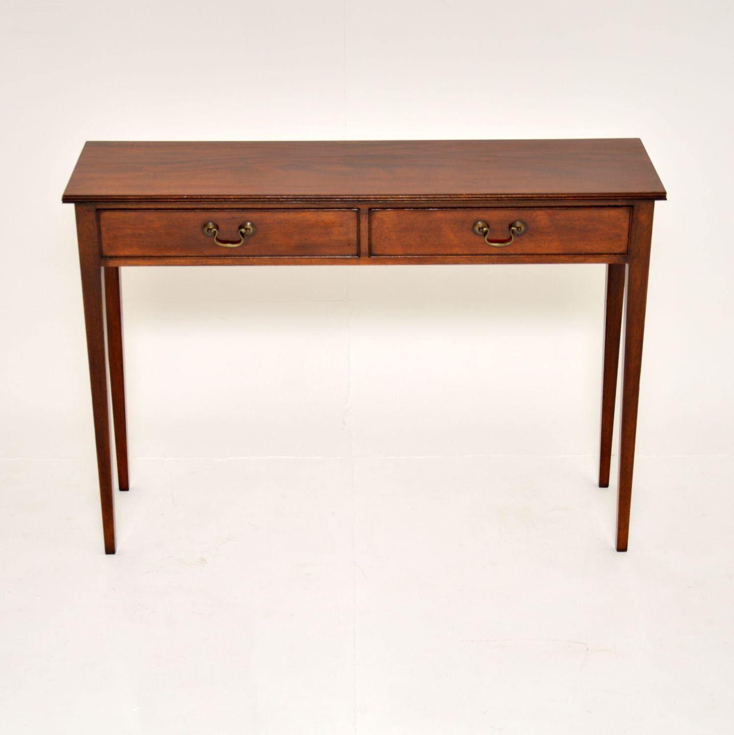 A beautiful antique two drawer console table in the Georgian style. This was made in England & I would date it from around the 1930-50’s period, although the wood looks much older, so this could have been re-constructed from antique timber.

This