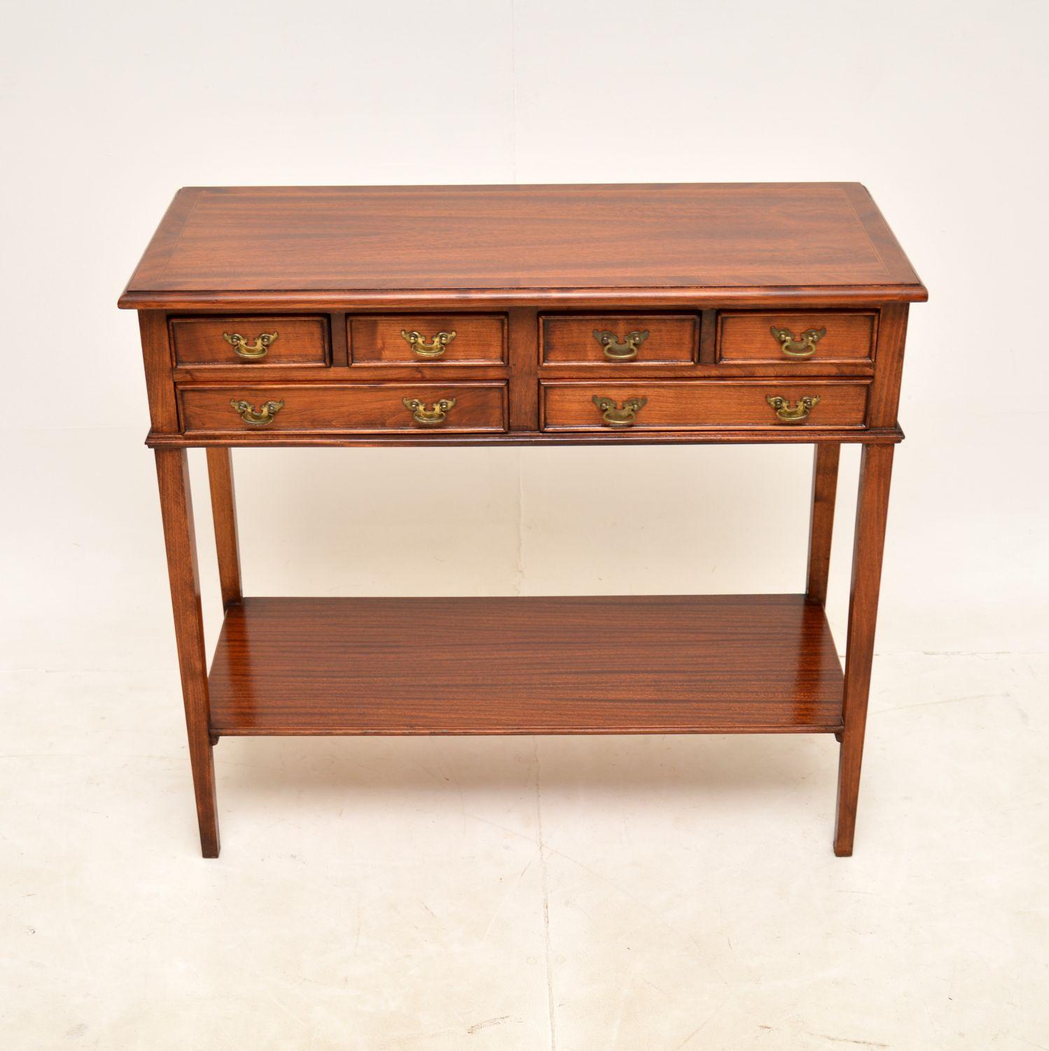 A lovely antique Georgian style console side table, made in England and dating from around the 1960’s.

This is of great quality, it is really well made. There are six slim drawers, a useful lower tier, this has a cross banded top and a polished