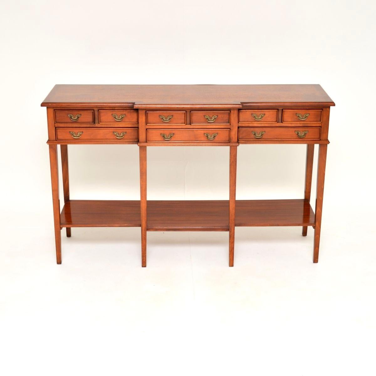 A lovely antique Georgian style console side table, made in England and dating from around the 1960’s.

This is of great quality, it is really well made from a combination of birch and other woods. It has a breakfront design with nine slim drawers,