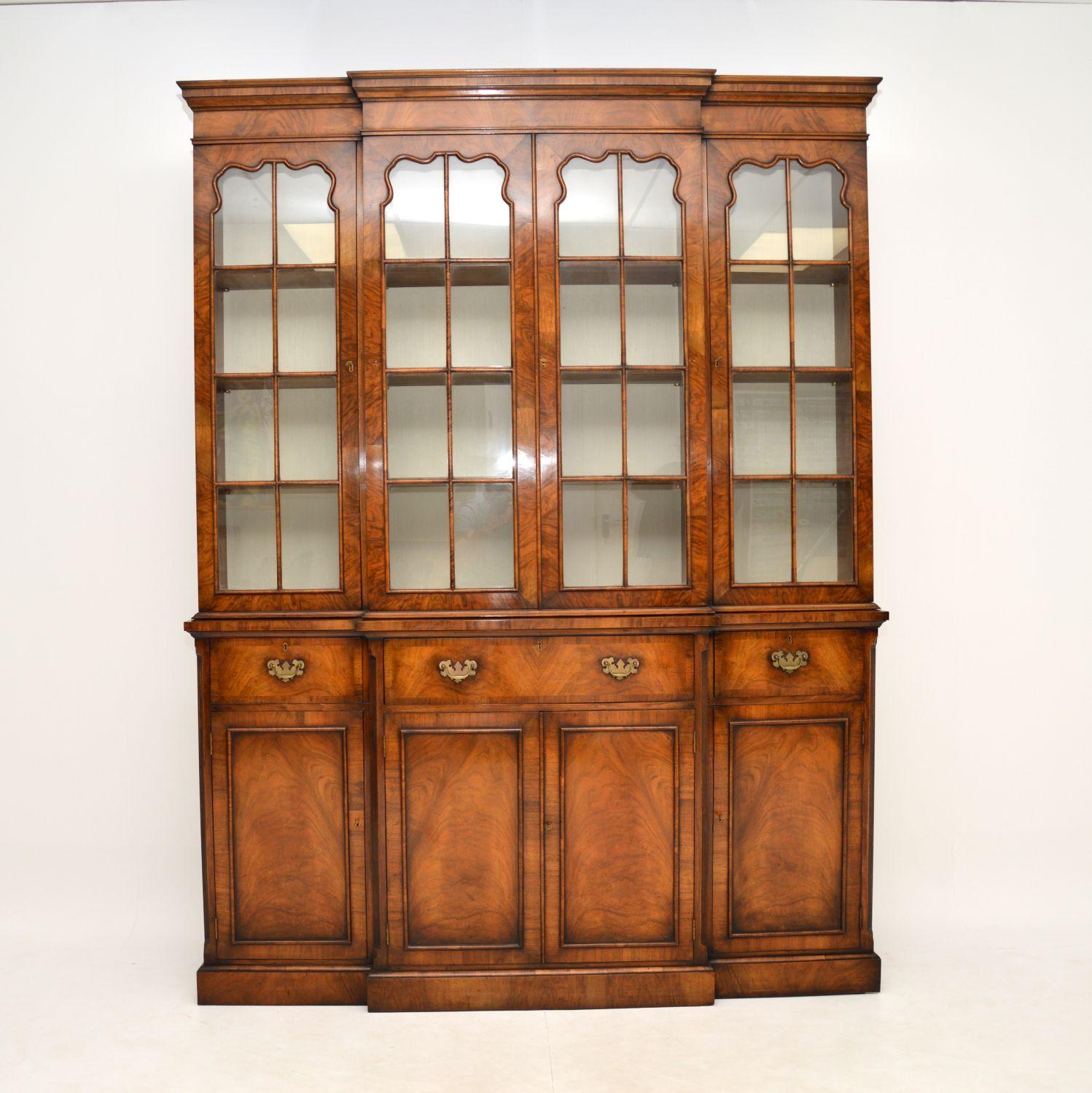 A large and very impressive walnut breakfront bookcase, in the antique Georgian style. This dates from around the 1950-60’s period.

It is of amazing quality, it is extremely well built and heavy. It is all solid wood construction, with stunning