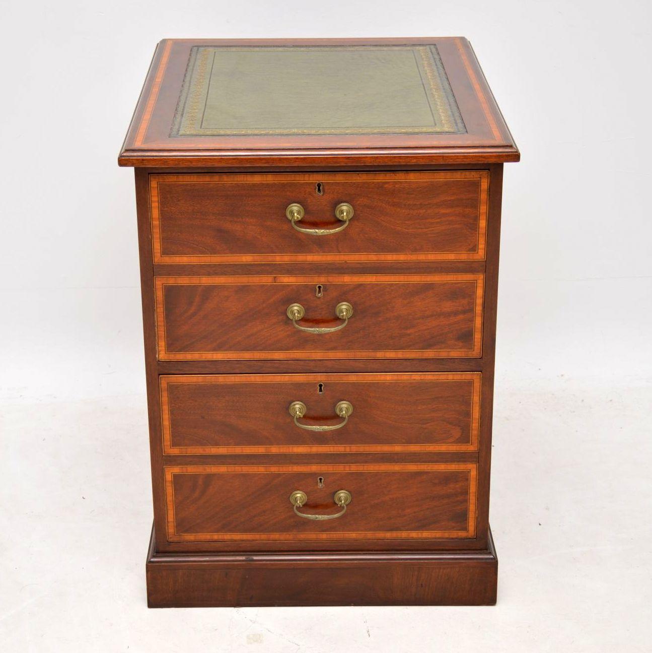 Antique Georgian style mahogany filing cabinet, with two deep filing drawers that look like four drawers when closed. This filing chest is in excellent condition & is about 40-50 years old. It has a tooled leather insert on the top, four brass