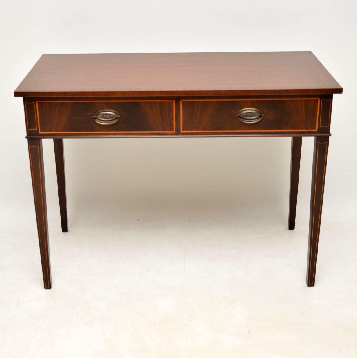 Antique Georgian style mahogany writing table or side table with fine satinwood inlays all-over. It’s in good condition, having just been French polished & dates from the circa 1930-1950s period. The polished mahogany top is inlaid & crossbanded.