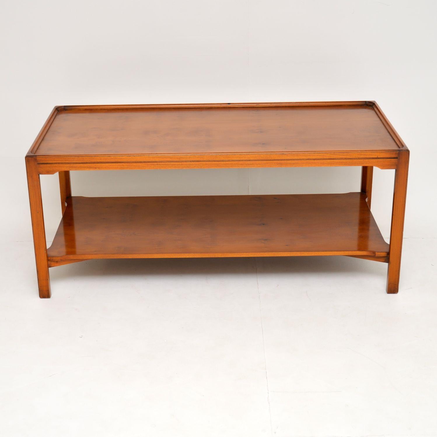 Large antique Georgian style yew wood coffee table dating from circa 1950s period and in excellent condition.

It’s a very practical table, having that bottom section for extra storage & it has a lovely mellow colour. It’s also of very solid