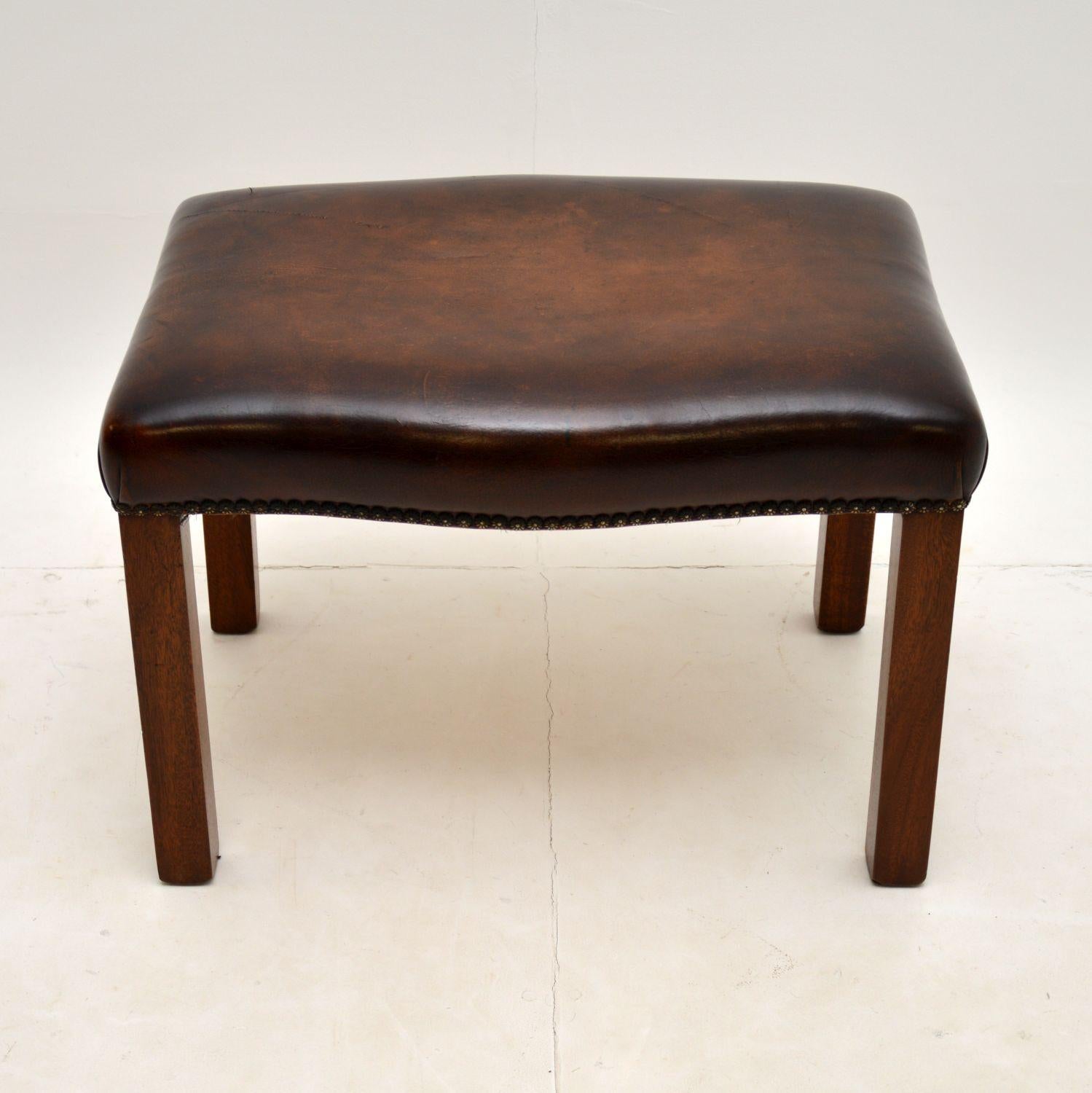 An excellent leather and mahogany stool, in the antique Georgian Chippendale style. This was made in England, it dates from around the 1930-50’s.

The shape is lovely and this is of excellent quality. The brown leather has been professionally hand