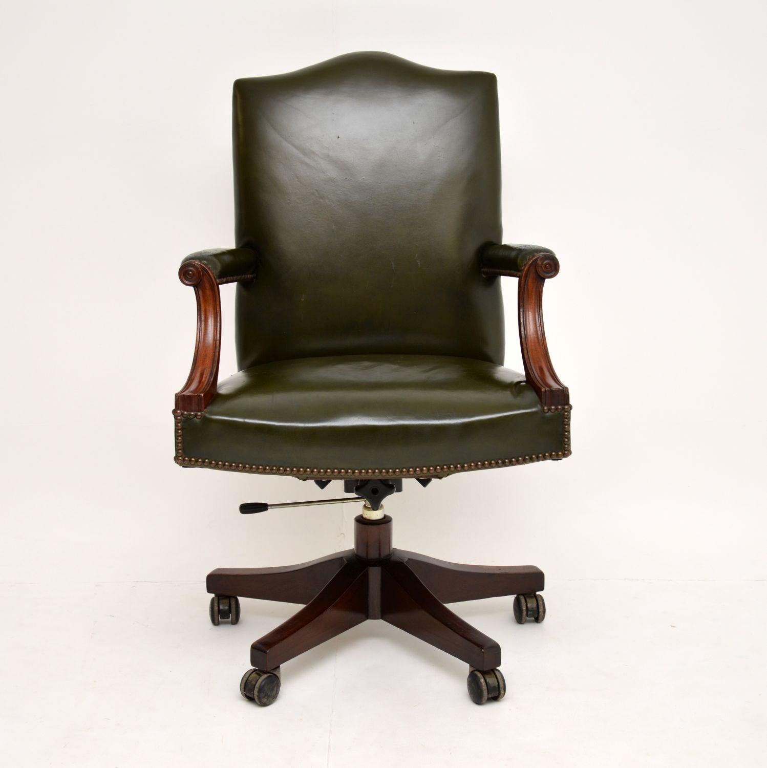A smart and extremely comfortable vintage leather desk chair, in the antique Georgian style. This dates from circa 1950s, it is of excellent quality.

The green leather has been professionally hand coloured and revived by our leather restorer.