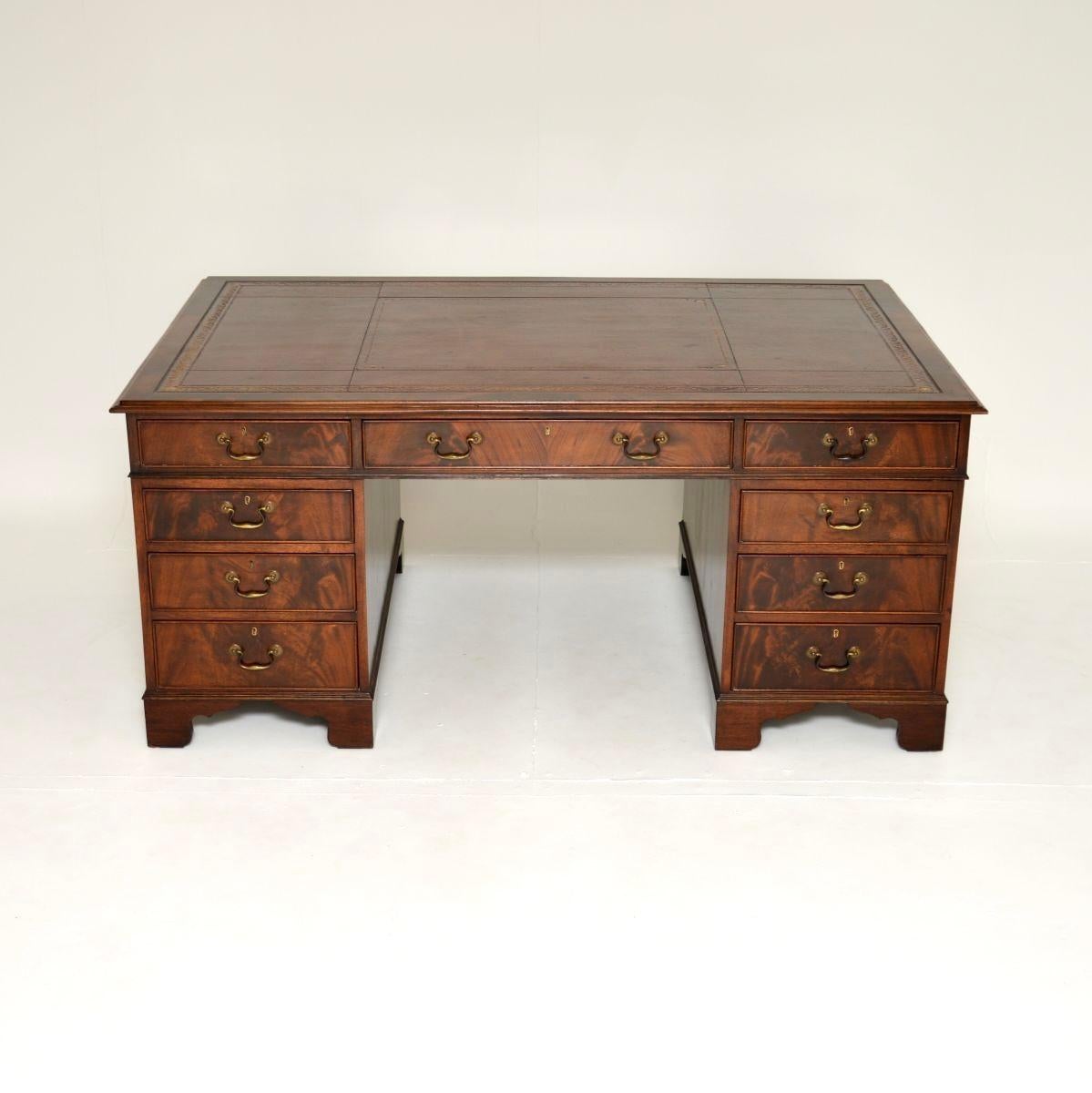A magnificent antique leather top partners desk. This was made in England, it dates from around the 1920’s period.

It is of extremely high quality, and is a large and impressive piece. The front has lots of drawers and storage space as you would