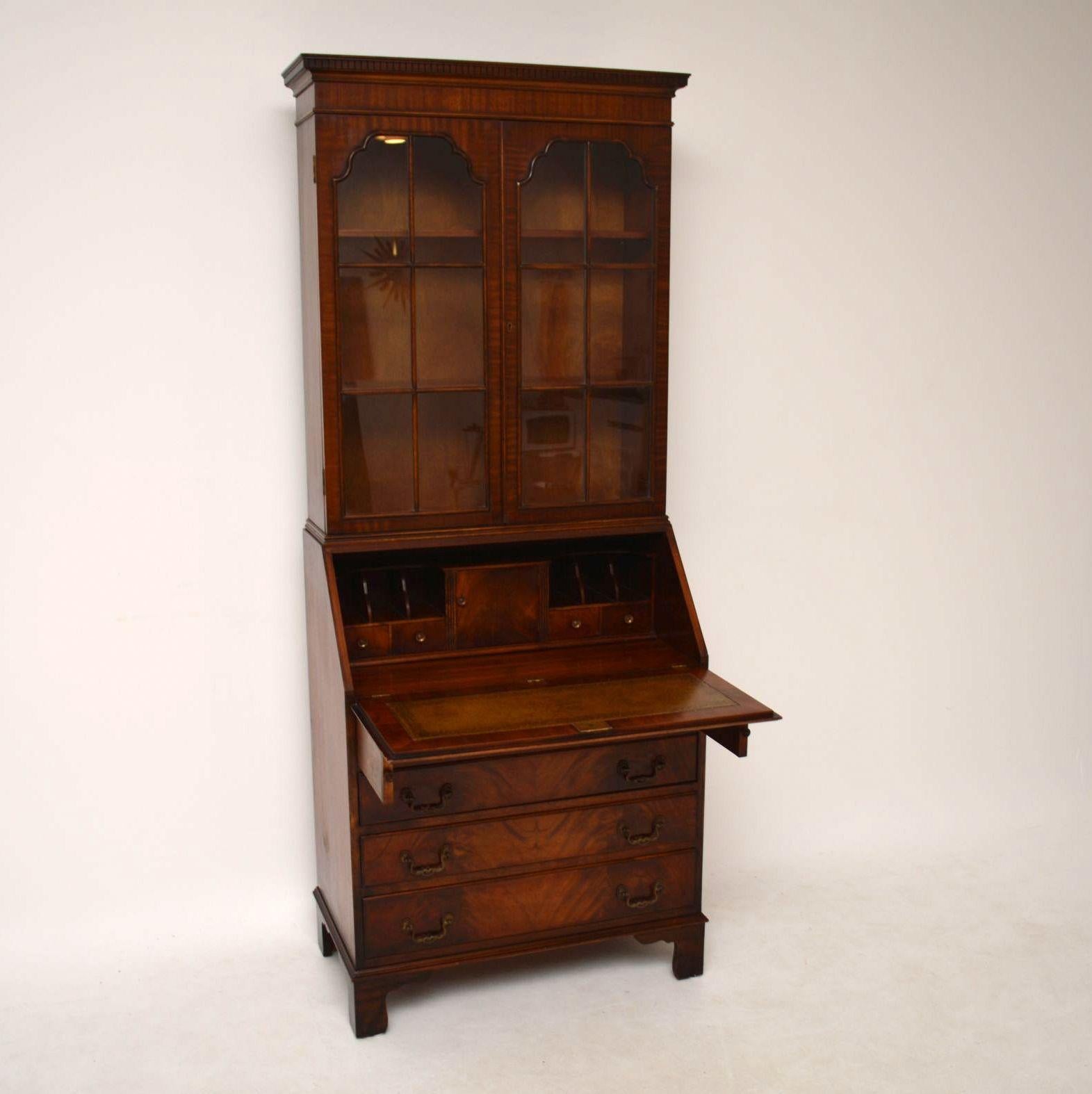 Antique Georgian style mahogany bureau bookcase in excellent condition & dating from around the 1950’s period. It has double arched astral-glazed doors, with adjustable bookshelves inside. The writing section has a fine array of small drawers, a