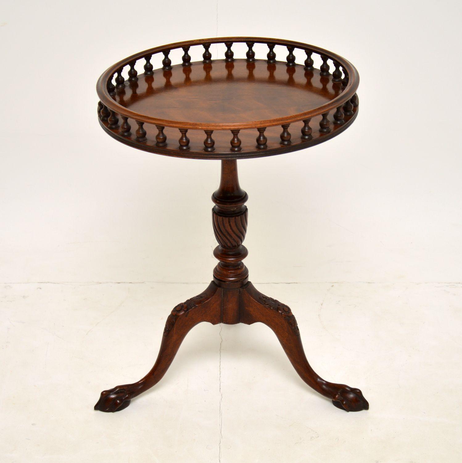 A charming mahogany gallery top side table, in the antique Georgian style. This dates from around the 1930’s & it was made in England.

The quality is excellent, this has a beautifully carved tripod base, with hairy paw feet. The gallery spindles