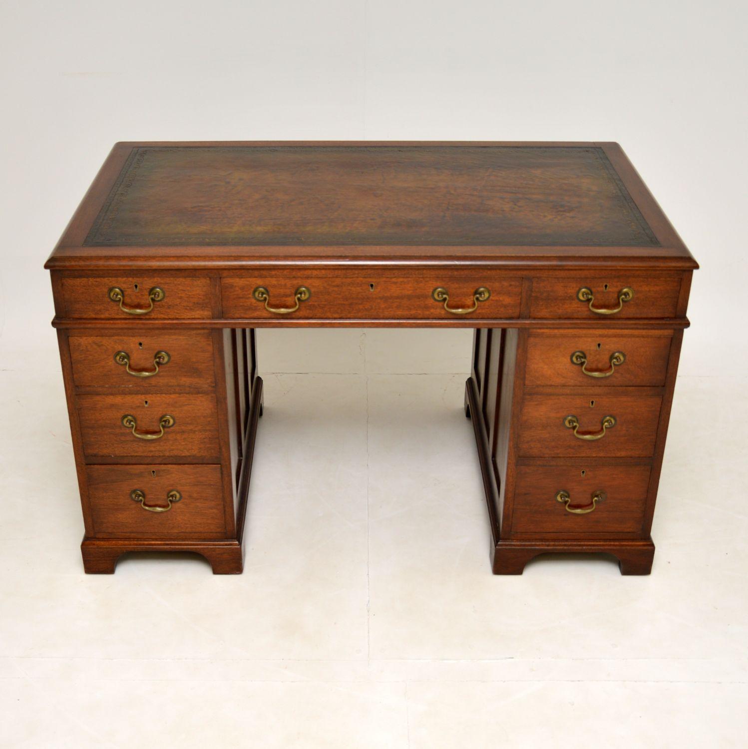 This antique Georgian style mahogany pedestal desk is a nice useful size with plenty of working area & a generous kneehole space. This was made in England and dates from around the 1920-30’s.

The quality is excellent, this is very well built and