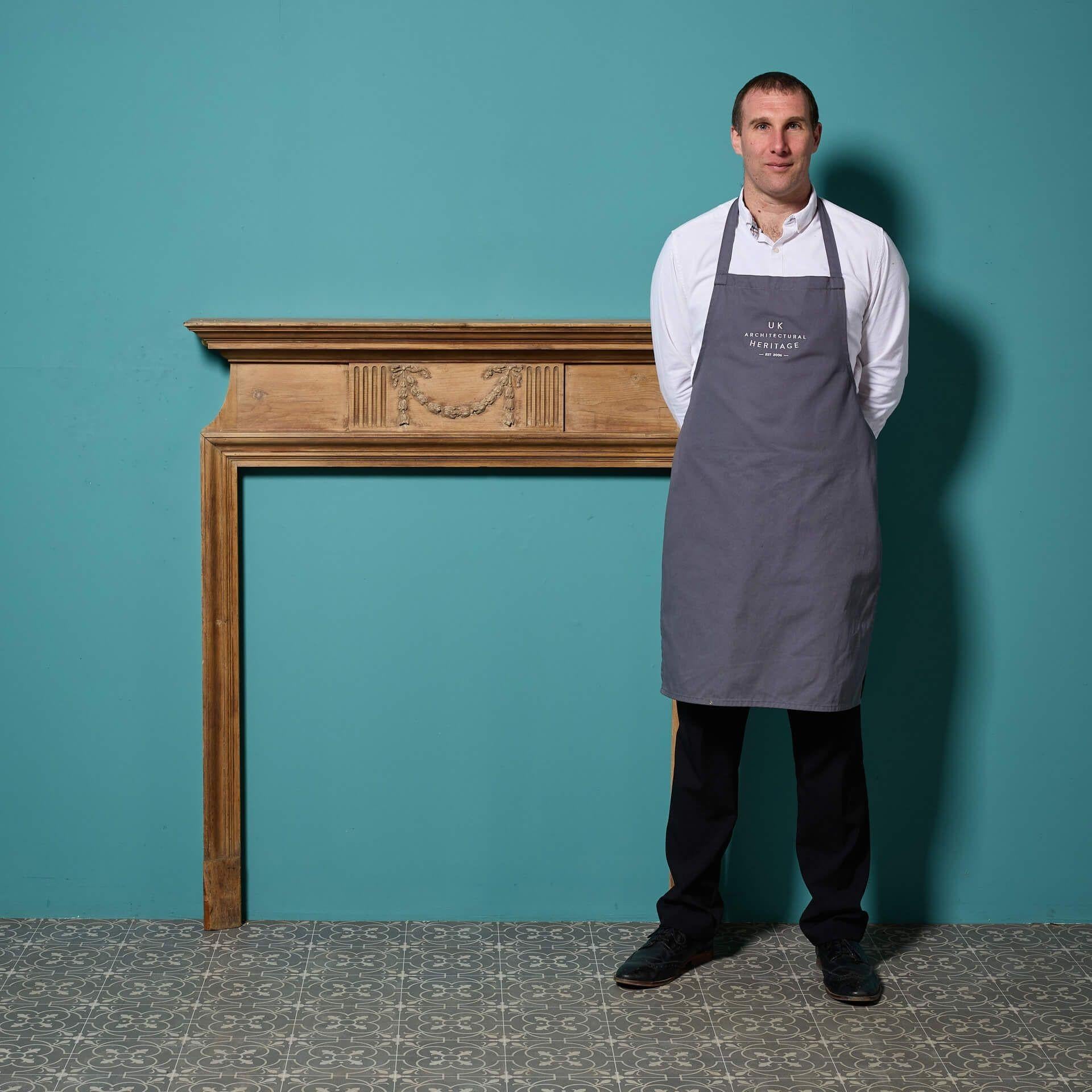 An antique Georgian style carved pine and composition fire surround.

Crafted from solid pine with a stripped and waxed finish this fire surround has an elegant compact and simple design.

Its slender jambs and beautiful fluted frieze panel centred