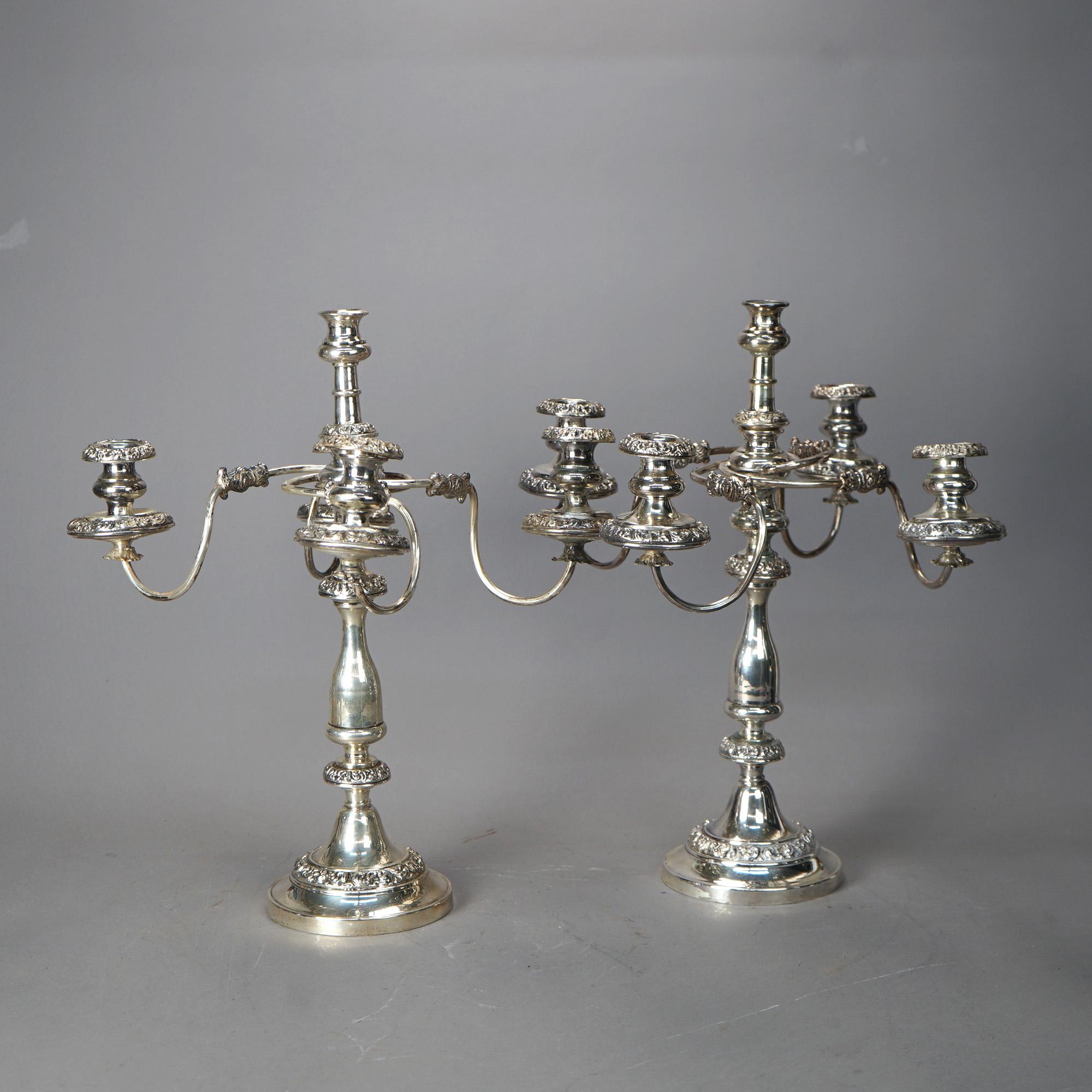 An antique pair of Georgian style candle sticks offer silver plate construction with scroll arms and five lights, c1900

Measures - 20