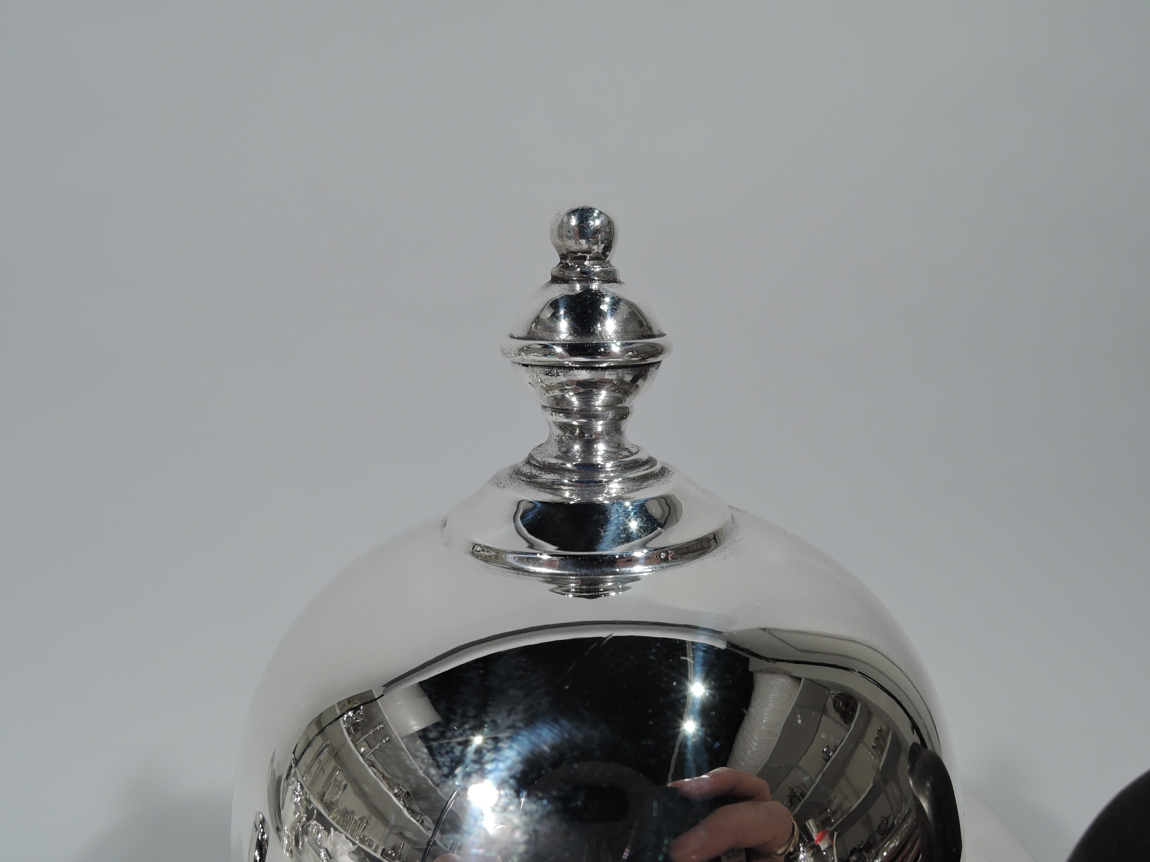 Georgian sterling silver coffeepot. Made by Watson in Attleboro, Mass, circa 1940. Truncated cone on spread base, S-scroll spout, and hinged and domed cover. Capped double-scroll handle is stained wood. Charming Old English style. Fully marked