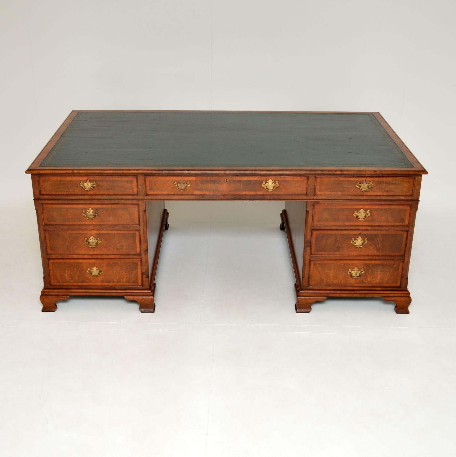 A very large and impressive figured walnut partners desk, in the antique Georgian style. This was made in England, it dates from around the 1950’s period.
The quality is outstanding, this is extremely well built and is of great proportions. The