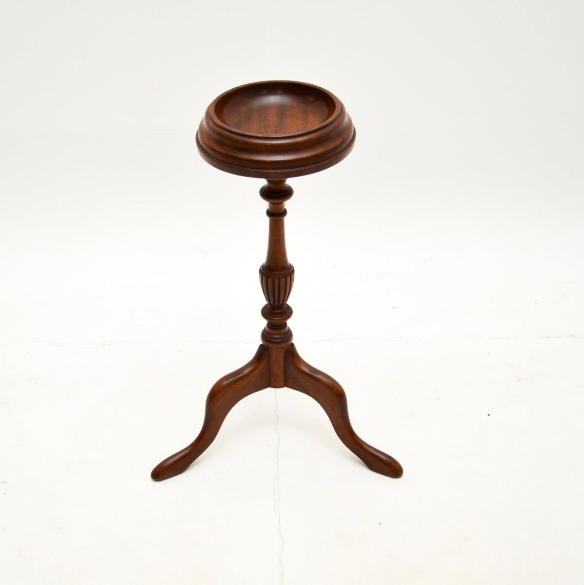 A lovely antique wine table / plant stand, made in England and dating from around the 1900-1910 period.

It is of very good quality, it is a useful, charming and quite unusual item. The circular top has a scooped out surface & we are not sure what