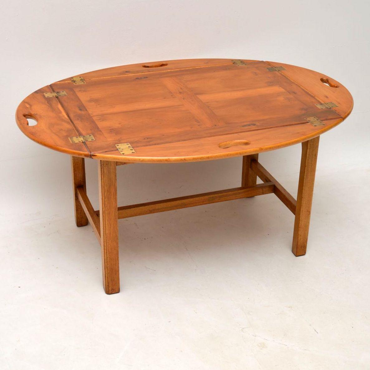 This yew wood butlers tray coffee table is in lovely condition and dates to circa 1950s period. It’s antique Georgian style, very well made and has just been French polished. I like the fact that the top tray section detaches and also the way that