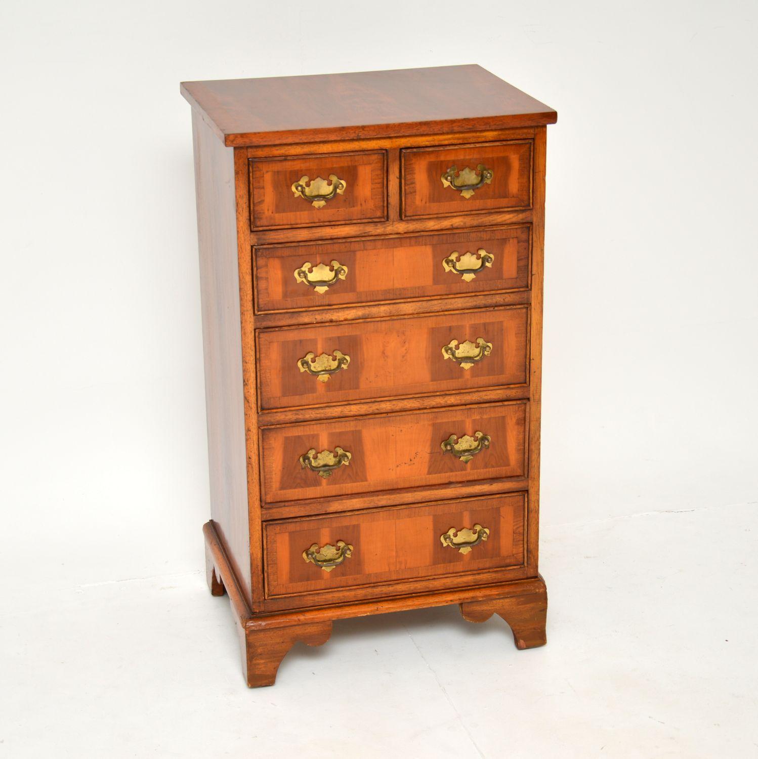 A smart and useful yew wood chest of drawers in the antique Georgian style. This was made in England & it dates from around the 1930-1950s period.

It is of lovely quality, with great proportions. The yew wood has a gorgeous colour tone and