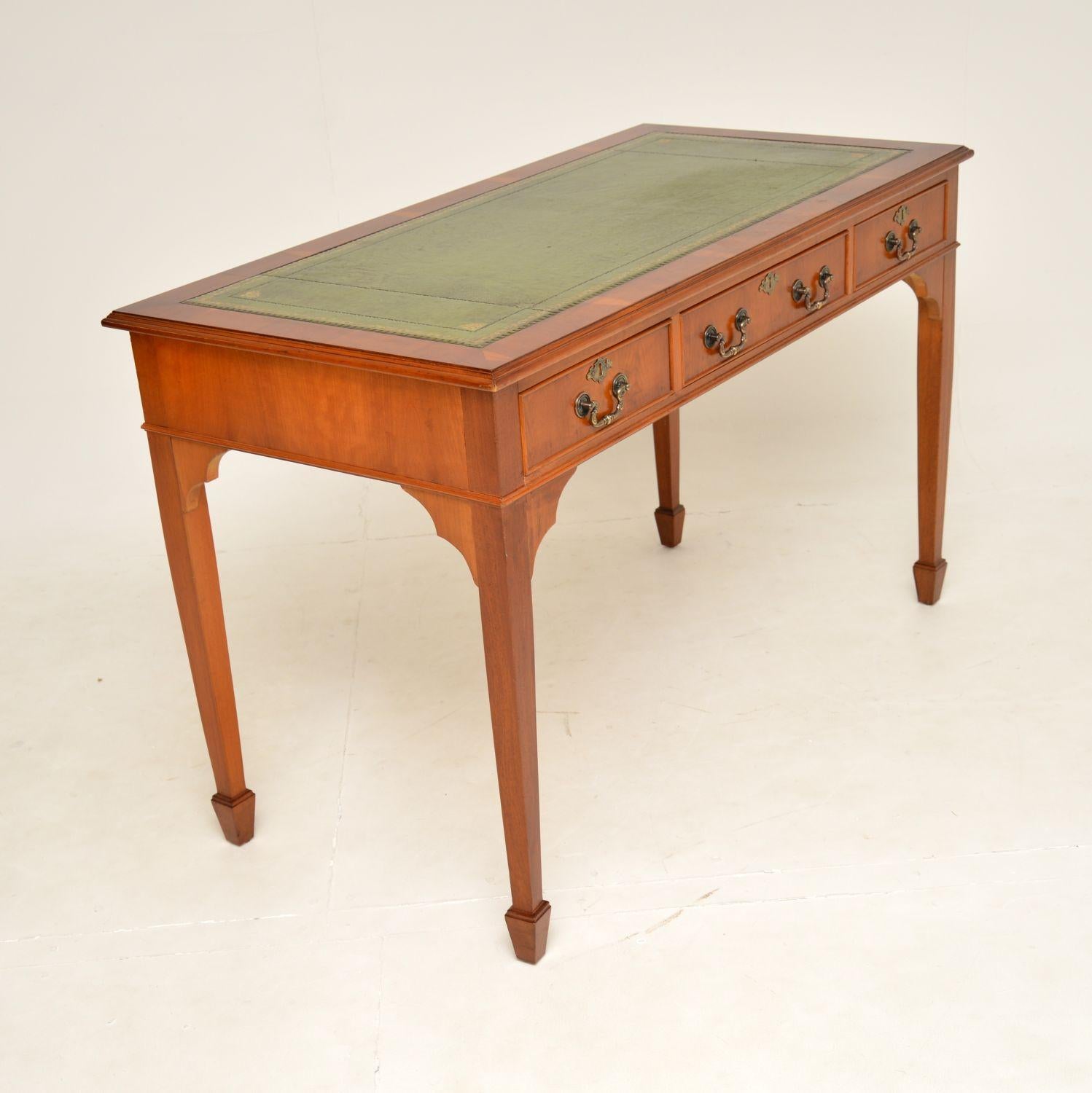 A very well made and great looking yew wood desk in the antique Georgian style. This was made in England, it dates from around the 1950’s.

It is a great size and is of very good quality. The yew wood has a lovely colour tone and beautiful grain