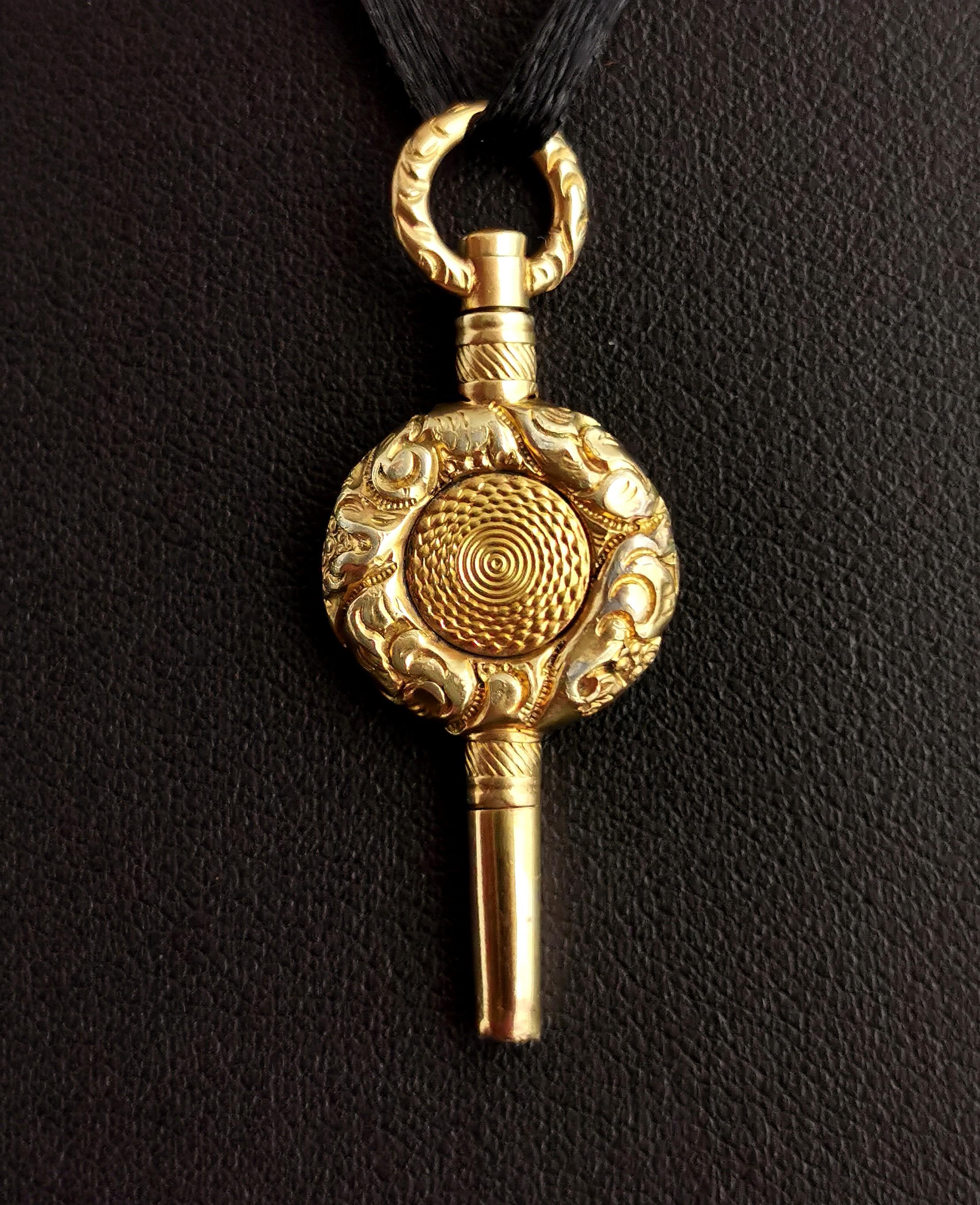 A charming antique, late Georgian era pocket watch key.

A good sized key with an engraved closed centre and a heavily chased and engraved rim and bow / bale.

It is a rich gold colour, 18kt yellow gold plated this key makes for a lovely pendant and