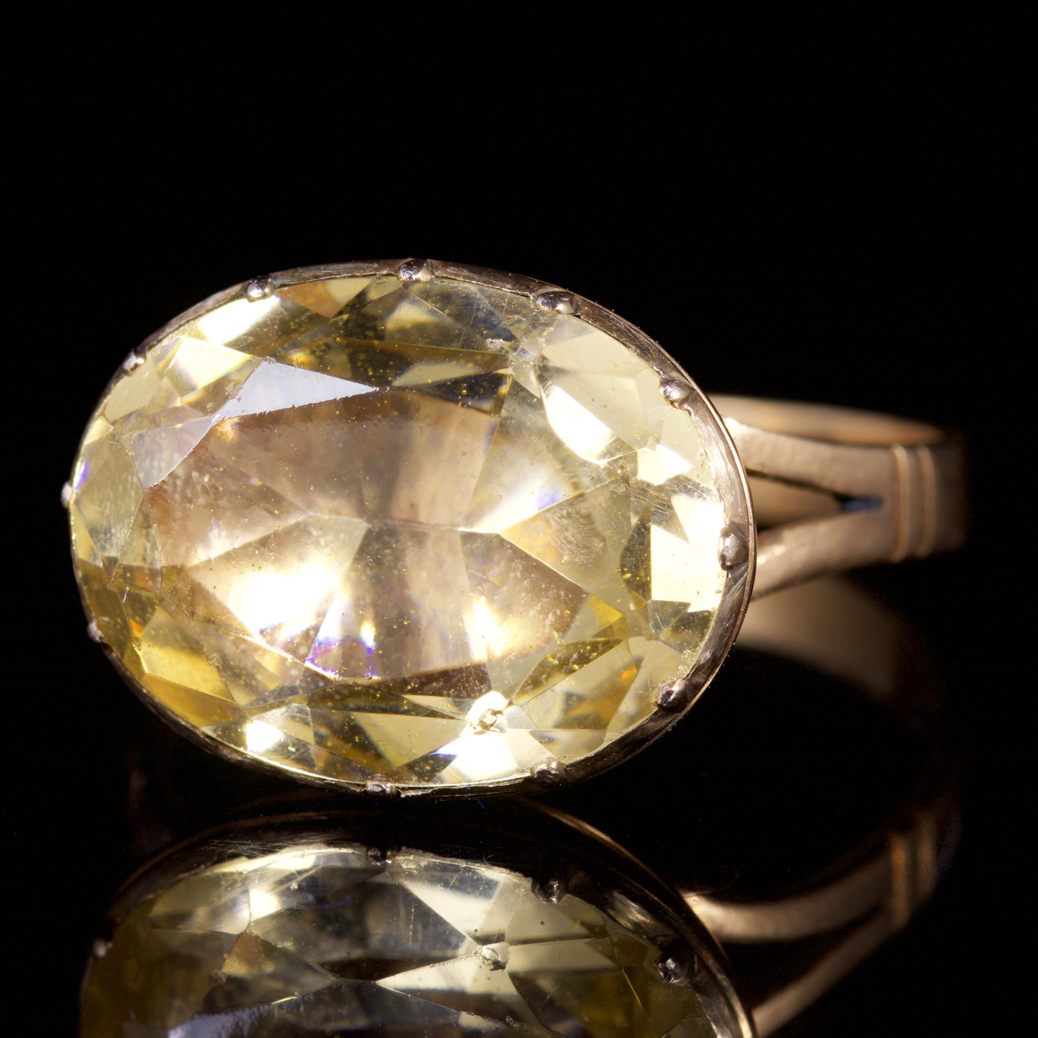 This fabulous Georgian is set with a central Yellow Topaz Paste Stone, Circa 1800.

The ring is set with a beautiful Topaz Paste Stone that is over 6.5ct in size.

The ring is set in 18ct Gold and has developed a rosy hue with age.

A beautiful