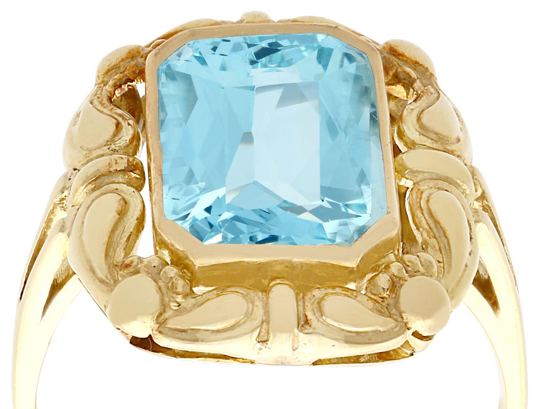 An impressive antique German 4.10 carat aquamarine, 8 karat yellow gold dress ring; part of our diverse antique jewelry and estate jewelry collections.

This stunning, fine and impressive antique gold emerald cut aquamarine ring has been crafted in