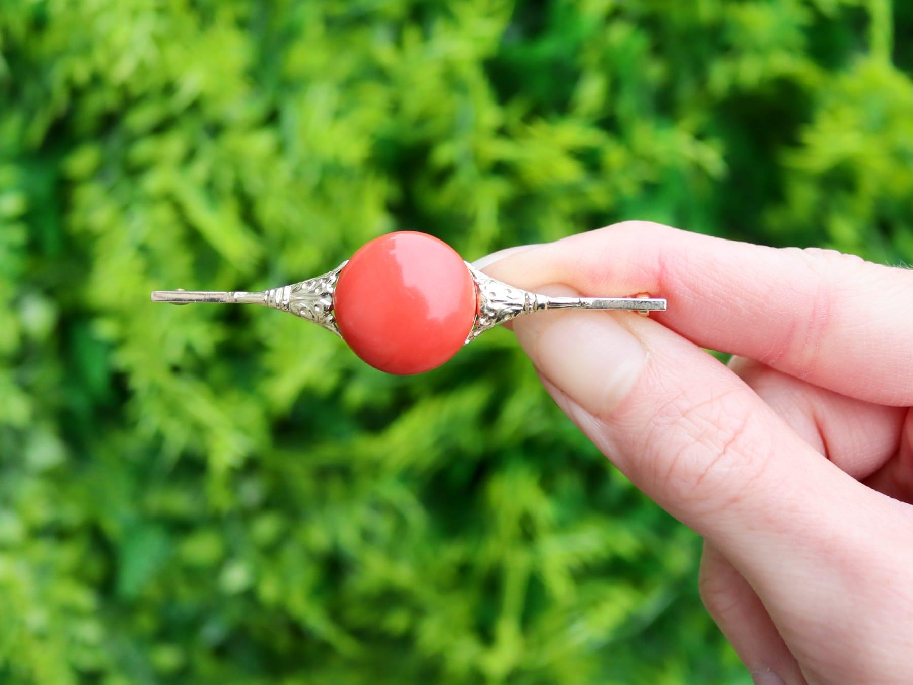 A fine and impressive antique 9.51 carat coral and 14 karat yellow gold bar brooch; part of our antique estate jewelry collections.

This impressive antique cabochon cut coral brooch has been crafted in 14k yellow.

The antique brooch features a