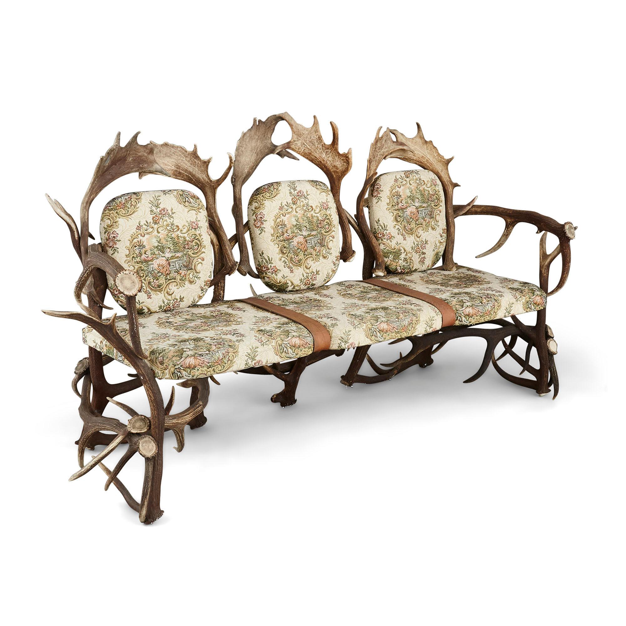Antique German antler settee with Rococo style upholstery
German, early 20th century
Dimensions: Height 108cm, width 212cm, depth 80cm

This unusual sofa, an example of 'antler-seat furniture', was likely crafted in Germany in the early 20th