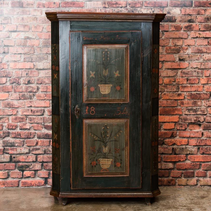 Likely created as a wedding gift and dated 1834, what makes this country armoire so exceptional is the original paint in remarkable condition. The painted floral design was a traditional German folk-art style element throughout the 1800s and is
