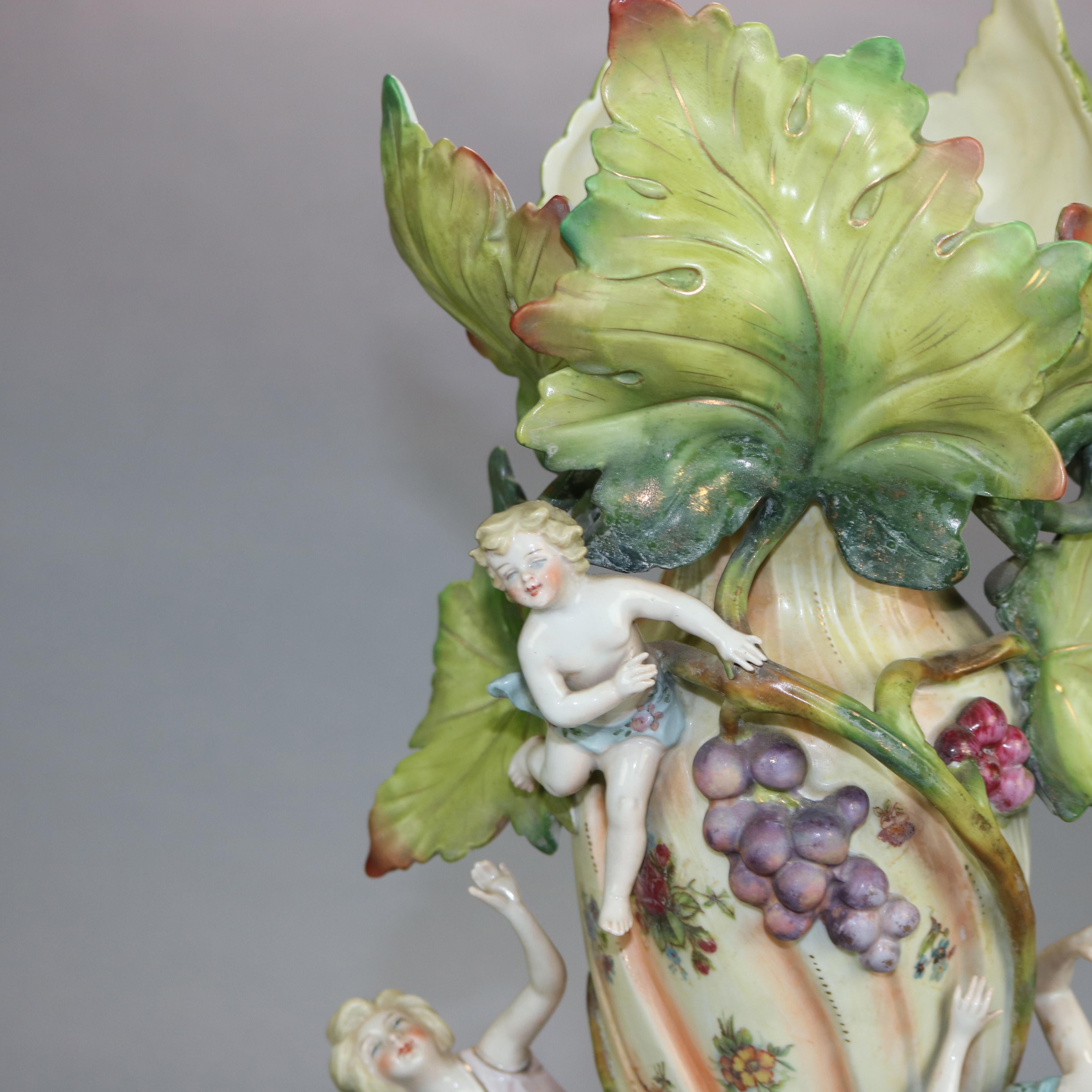 An antique German figural Art nouveau saxony vase offers porcelain construction with hand painted trunk with grapevine having female figures and child reaching upward toward leaf form mouth, stamped on base as photographed, c1900

Measures: 18.75
