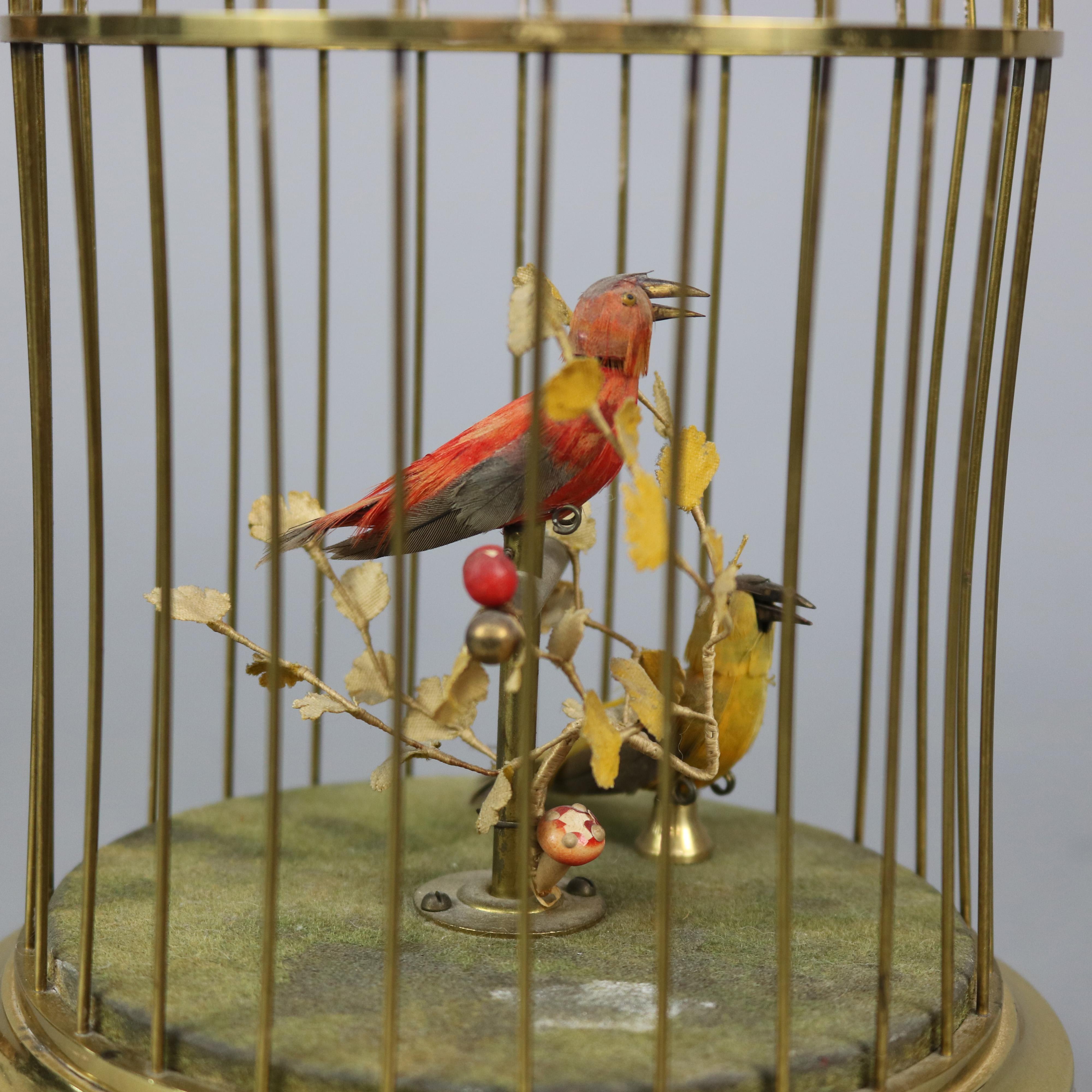 An antique German automaton music box offers two singing birds seated in brass cage with embossed foliate band and raised on ball feet, circa 1930.

Measures: 11