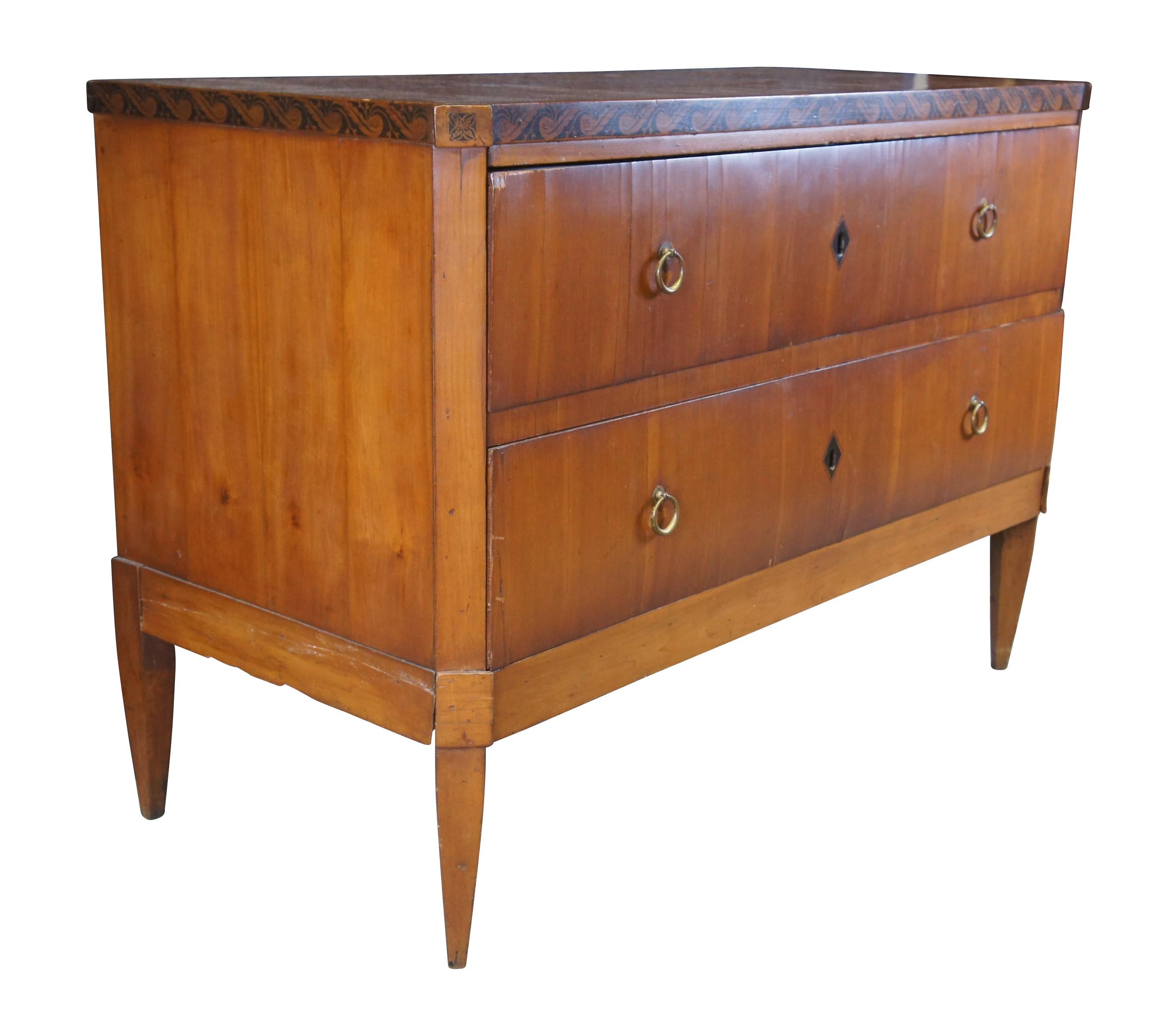 Antique German Biedermeier dresser / chest of drawers / console.  Made of cherry featuring rectangular form with wavecrest design and two drawers supported by tapered legs.  Circa mid to early 19th century.

Dimensions:
31.5