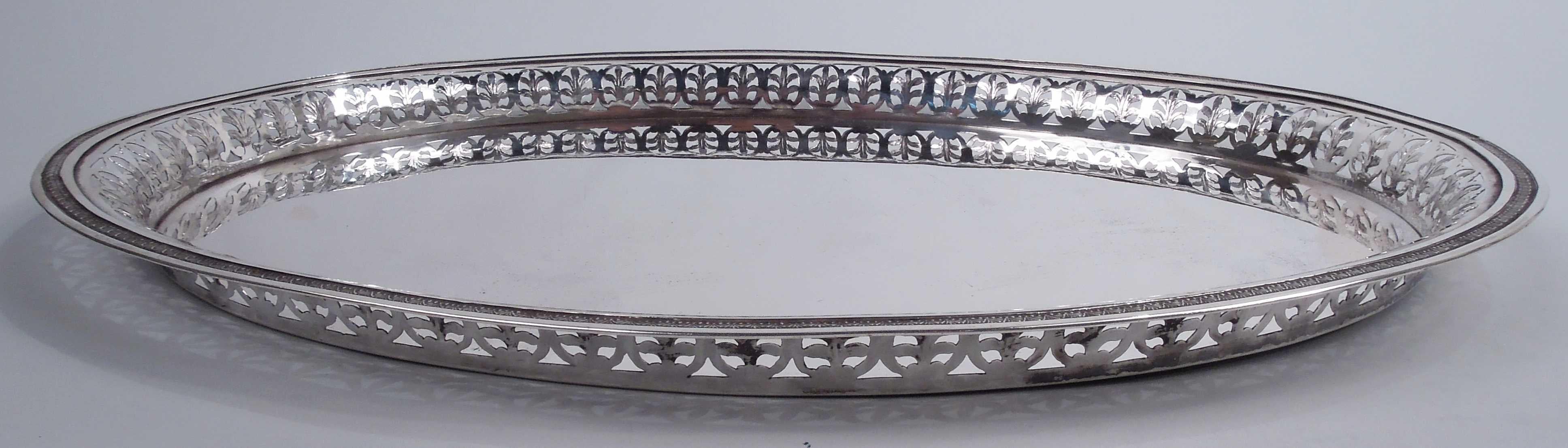 German Biedermeier Classical silver tray, ca 1860. Plain oval well. Sides have open border in form of leaves set in ovals. Cast leaf-and-dart rim on lined ground. A practical serving piece with lots of Mitteleuropa charm. Marked. Weight: 37 troy