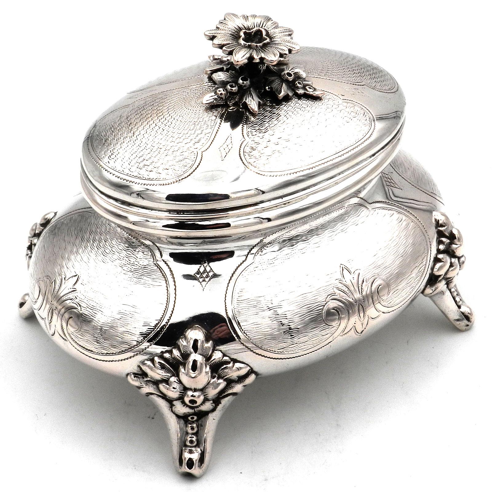 Antique German Biedermeier Silver Sugar Box circa 1870

Elegant sugar bowl on volute feet, oval, bulging body with engine-turned ornamental decoration and stylized flowers, domed cap lid with magnificent flower finial. Gold plated inside.

 

12
