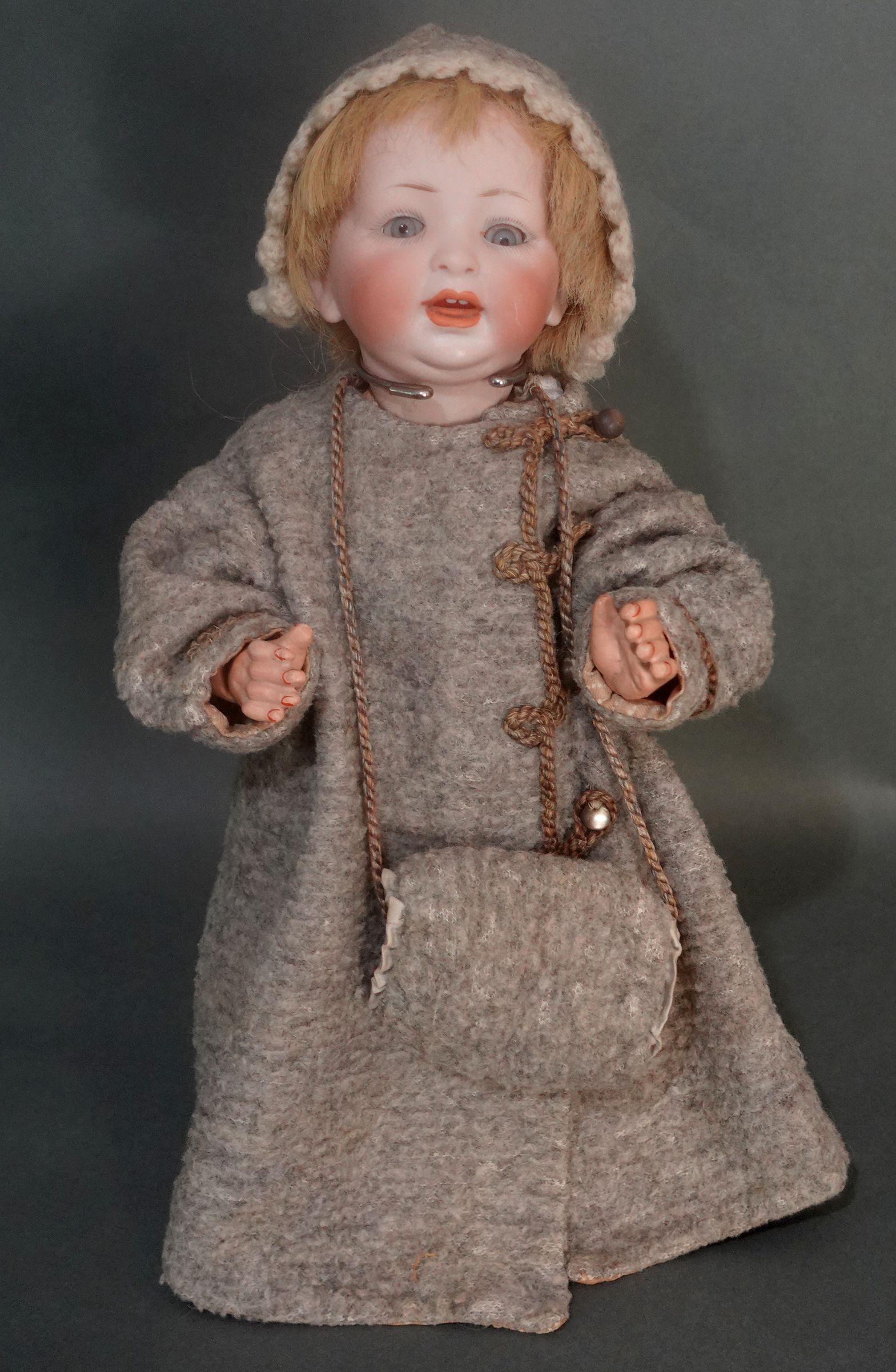 Antique Hertel Schwab baby doll. Measures approximately 13.5 inches in height. Beautiful blue glass sleep eyes with painted upper and lower lashes. Painted eyebrows. Open mouth with two upper teeth and a tongue.  The head is incised with: Made in