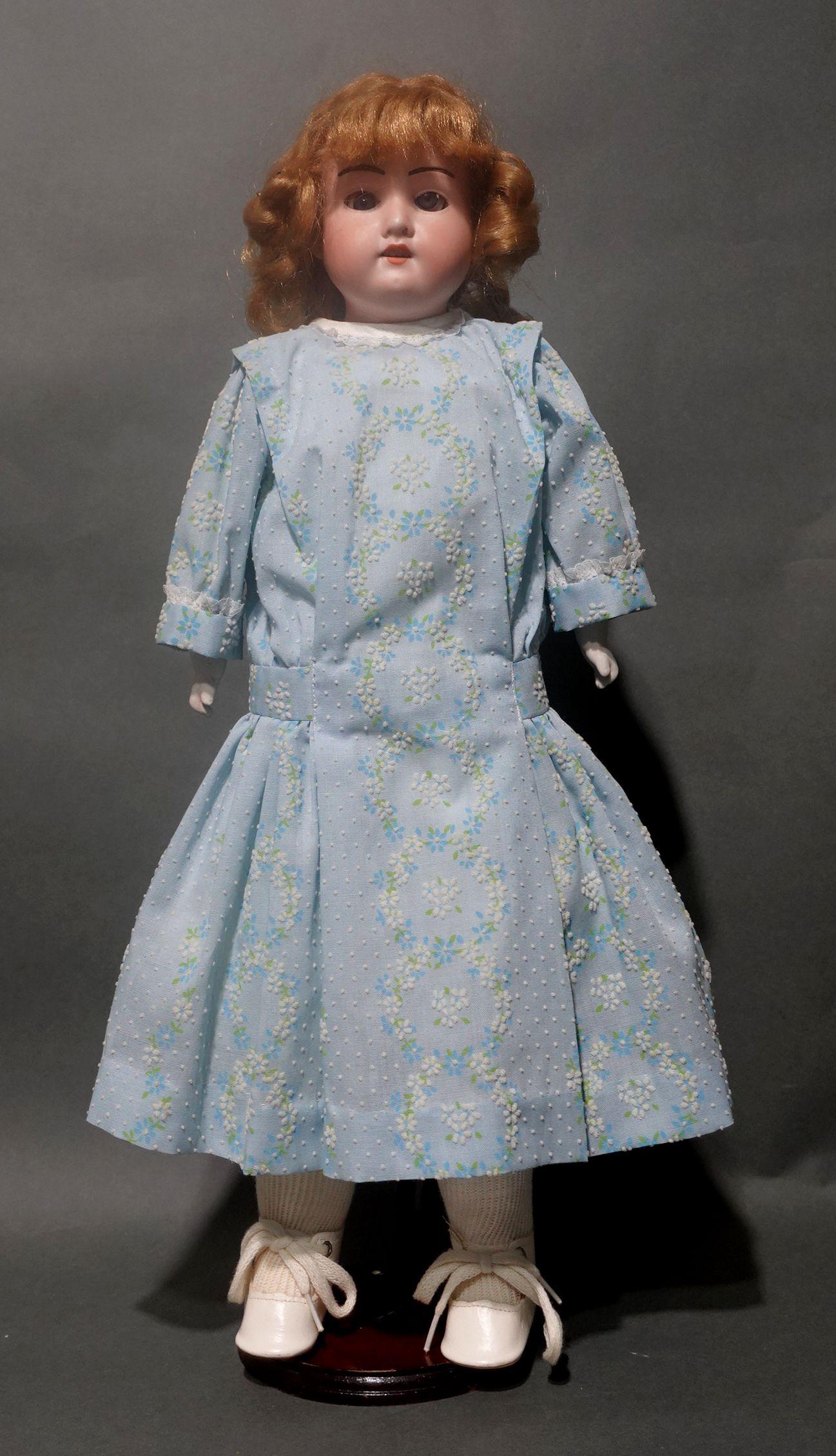 An original Armand Marseille doll, etched into the bisque at her nape is her edition number “370 AM-2/0X-DEP”. Bisque head and hands. Her feet wear perfect little white leather shoes with buttons. Beautiful blue glass eyes that seamlessly open and