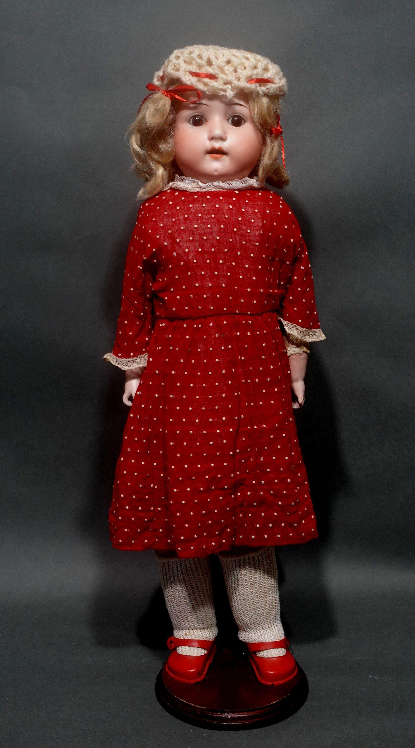 An original Armand Marseille doll, etched into the bisque at her nape with a Bisque head and hands. Her feet wear perfect little red leather shoes with buttons. Beautiful blue glass eyes that seamlessly open and close and her parted lips show her