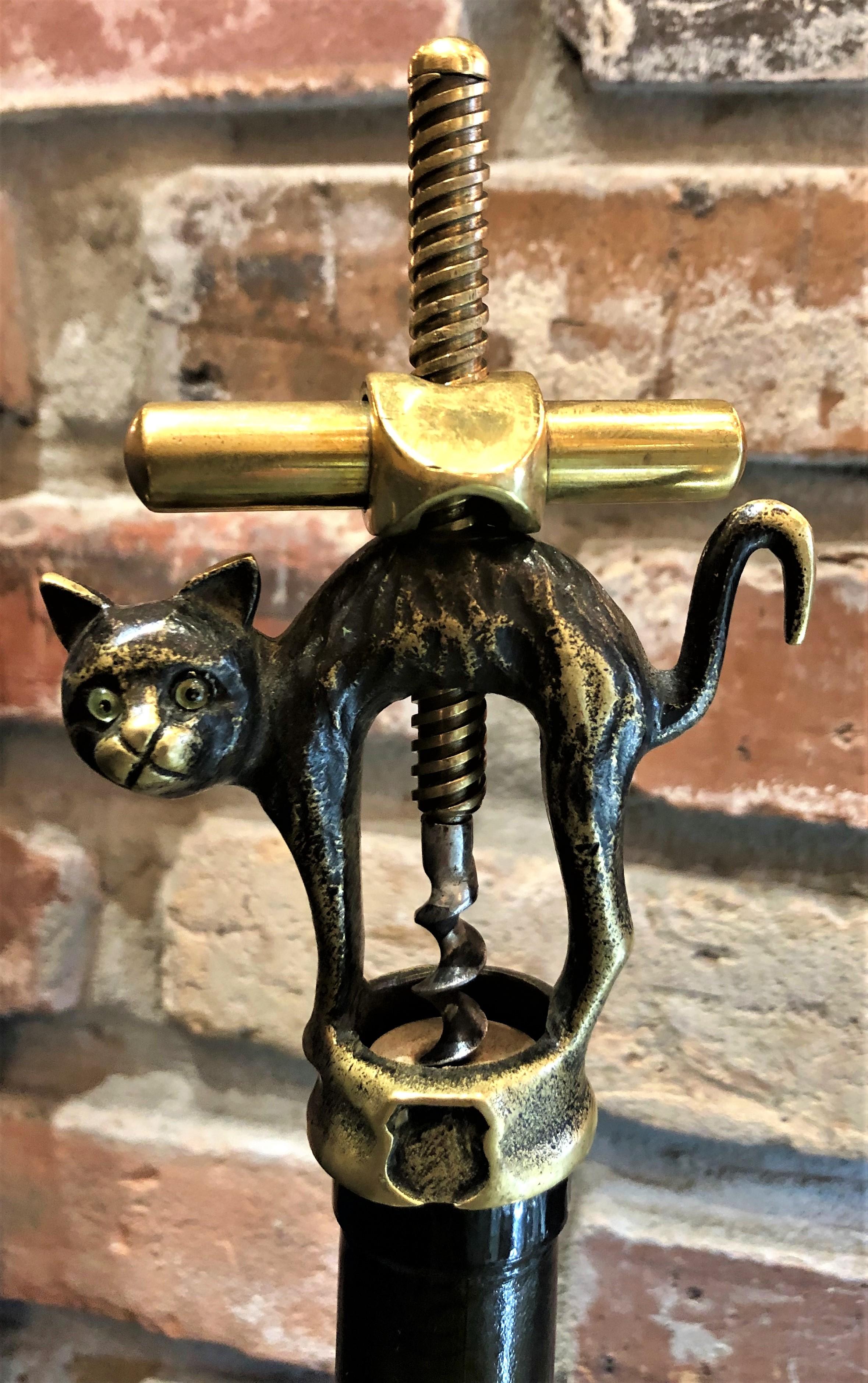 Antique German cast brass black cat corkscrew by Monopol Usbeck Co., circa 1900-1930.