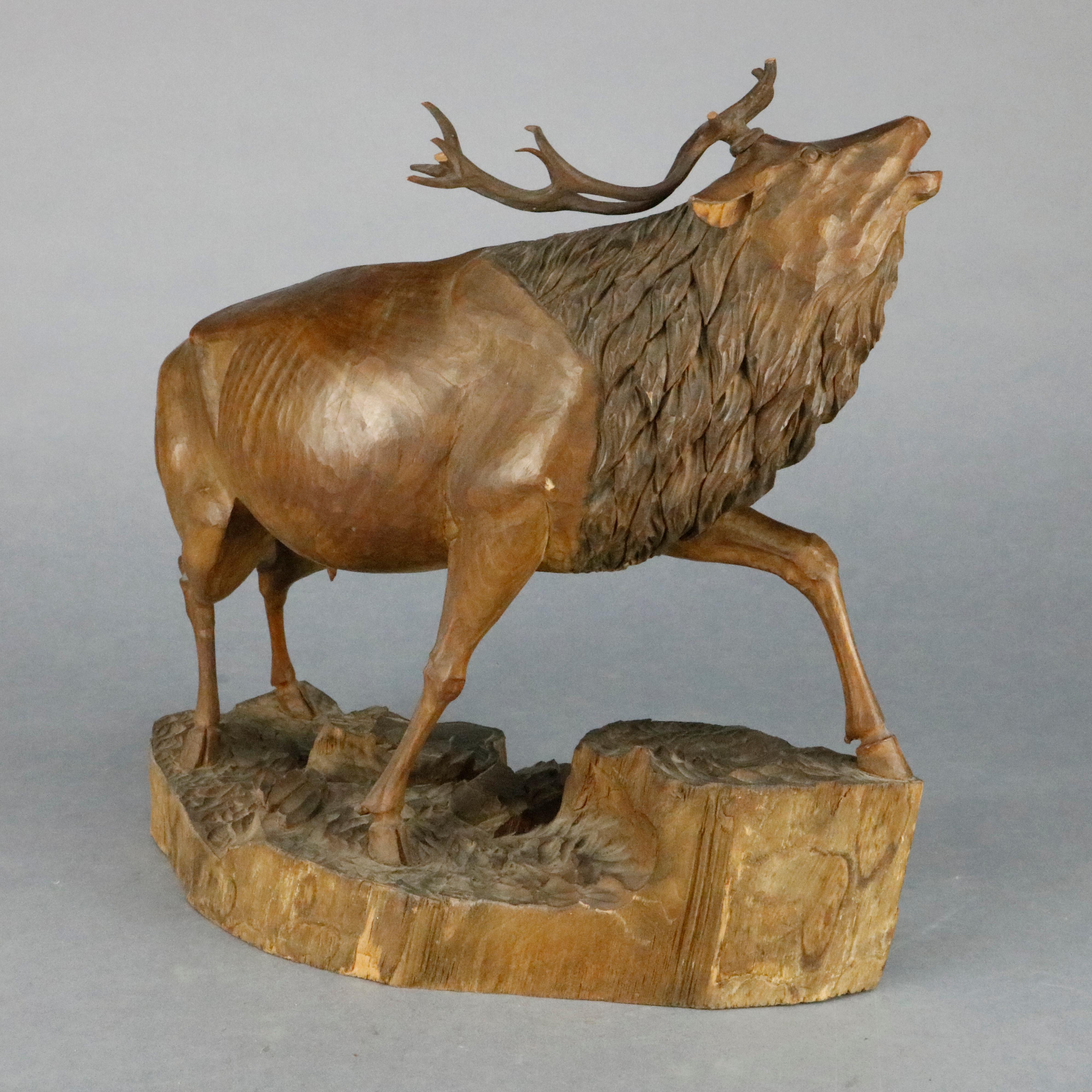 An antique German Black Forest sculpture depicts hand carved wood bugling elk climbing mountain in countryside setting, circa 1890

Measures: 14.75