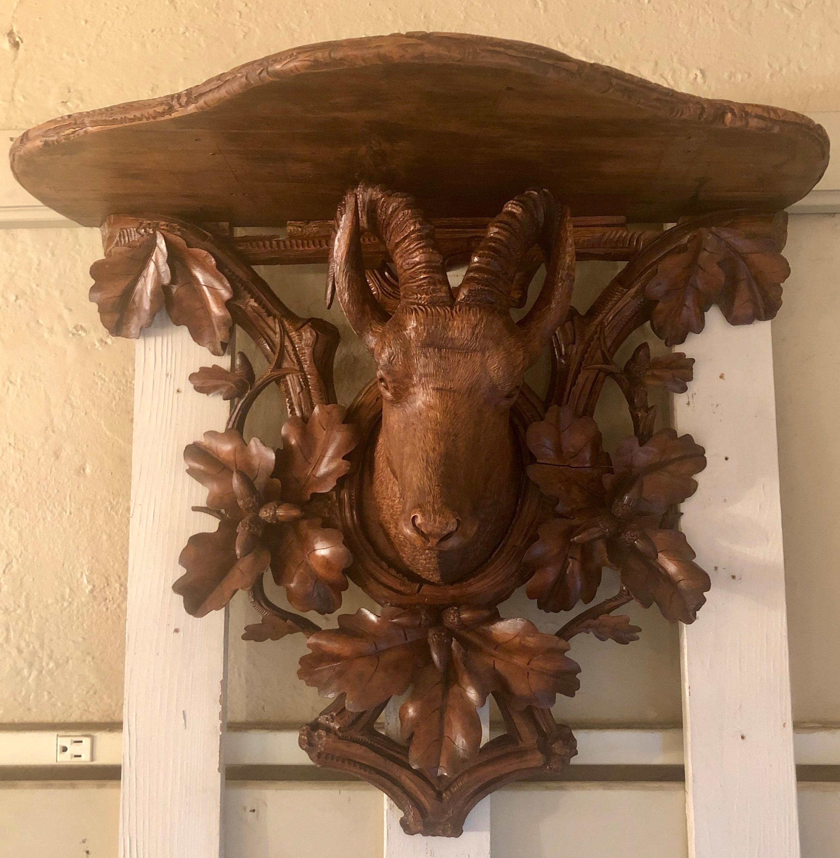 Antique German black forest walnut-carved shelf, circa 1890-1900.
Group photo: Pair smaller wall brackets listed separately.